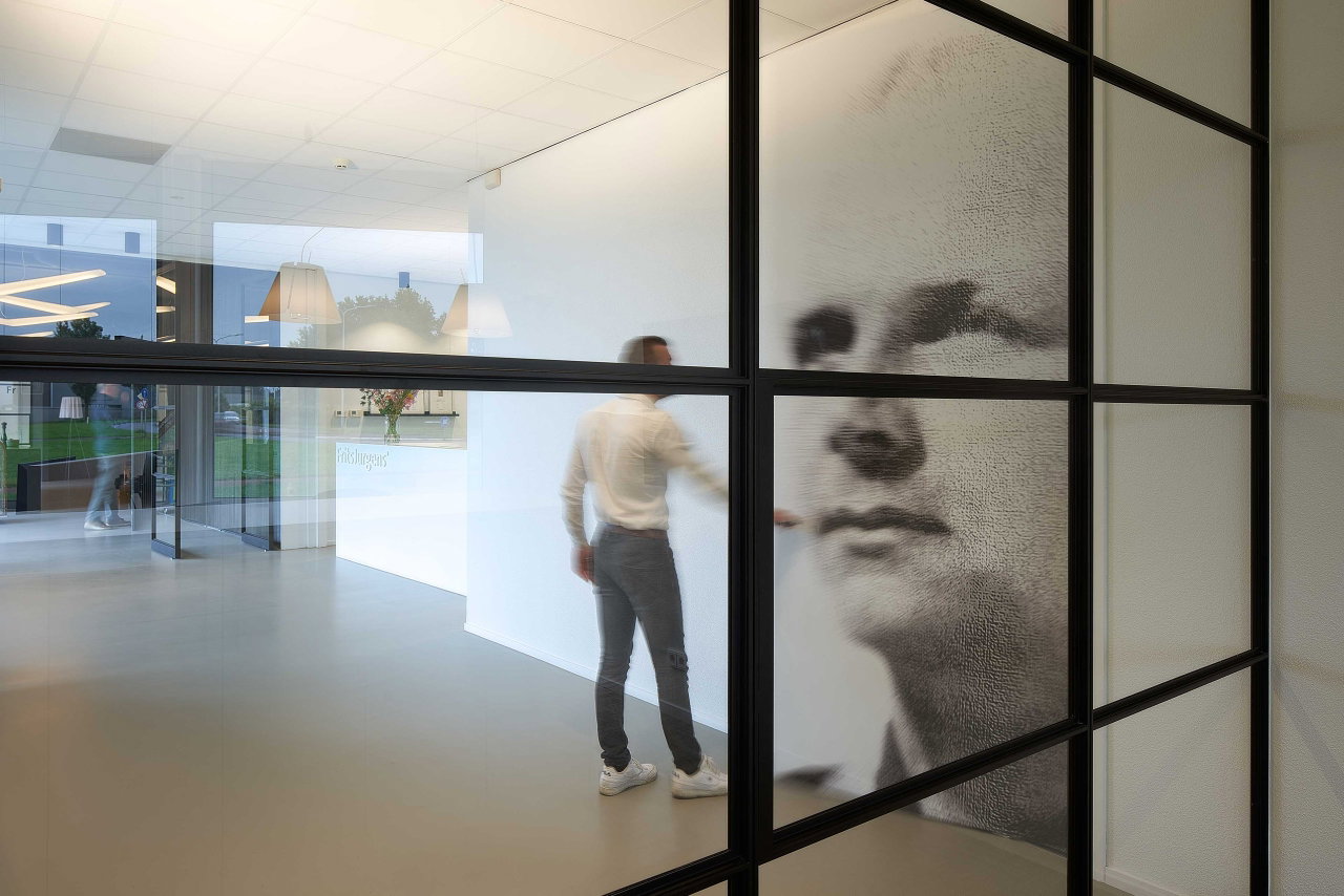 Steel and glass pivot door in an office in Kolham with FritsJurgens System One pivot hinge system inside