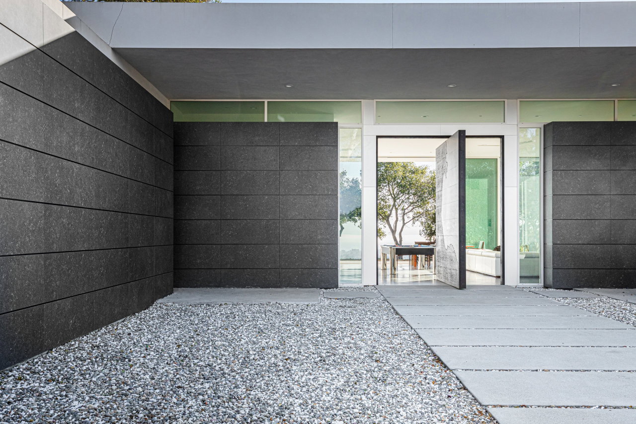 Wooden pivot door in a private home in Santa Cruz with FritsJurgens System M pivot hinge system inside