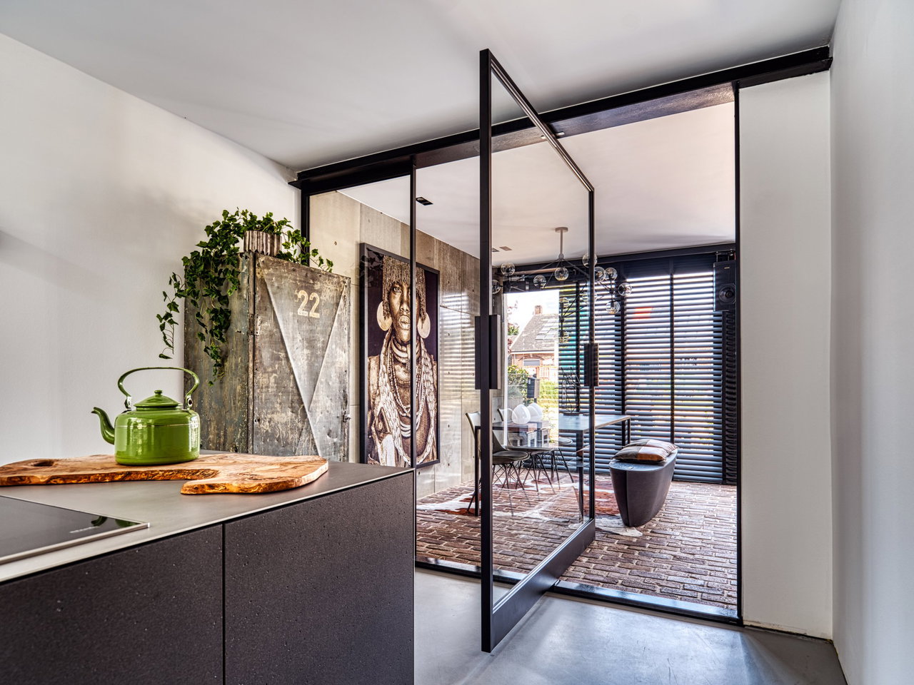 Steel and glass pivot door in a private home in Ede with FritsJurgens System 3 pivot hinge system inside