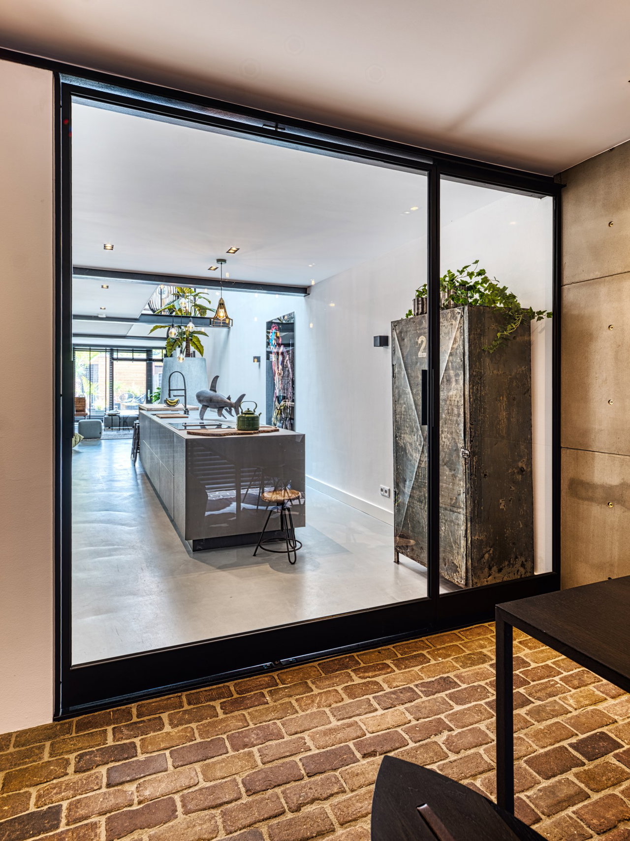 Steel and glass pivot door in a private home in Ede with FritsJurgens System 3 pivot hinge system inside