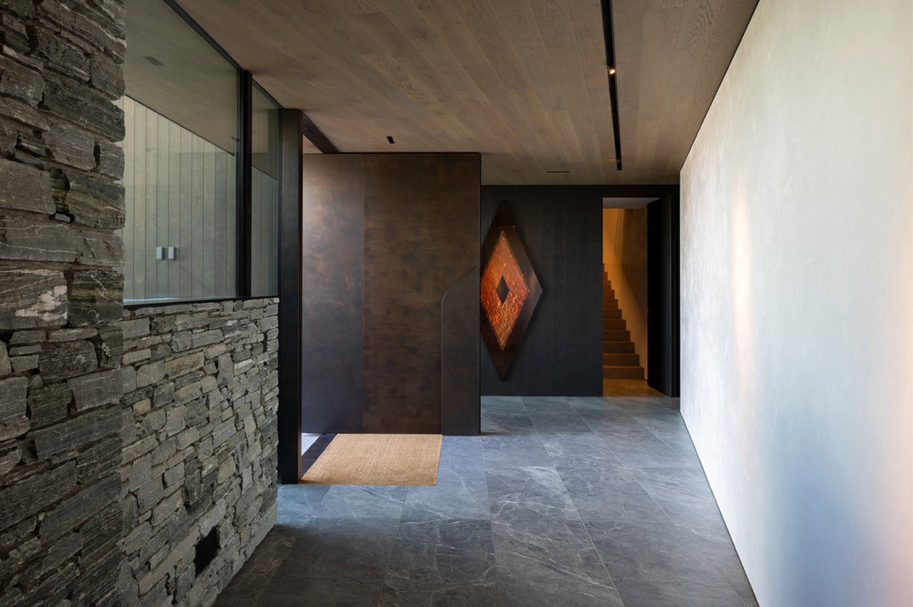 Aluminium pivot door in a private home in Queenstown with FritsJurgens System M pivot hinge system inside
