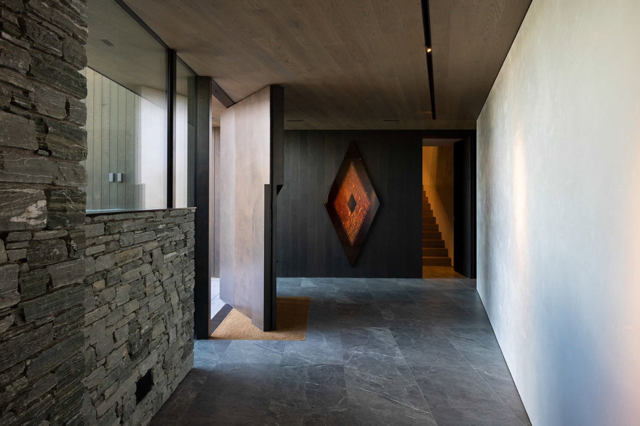 Aluminium pivot door in a private home in Queenstown with FritsJurgens System M pivot hinge system inside