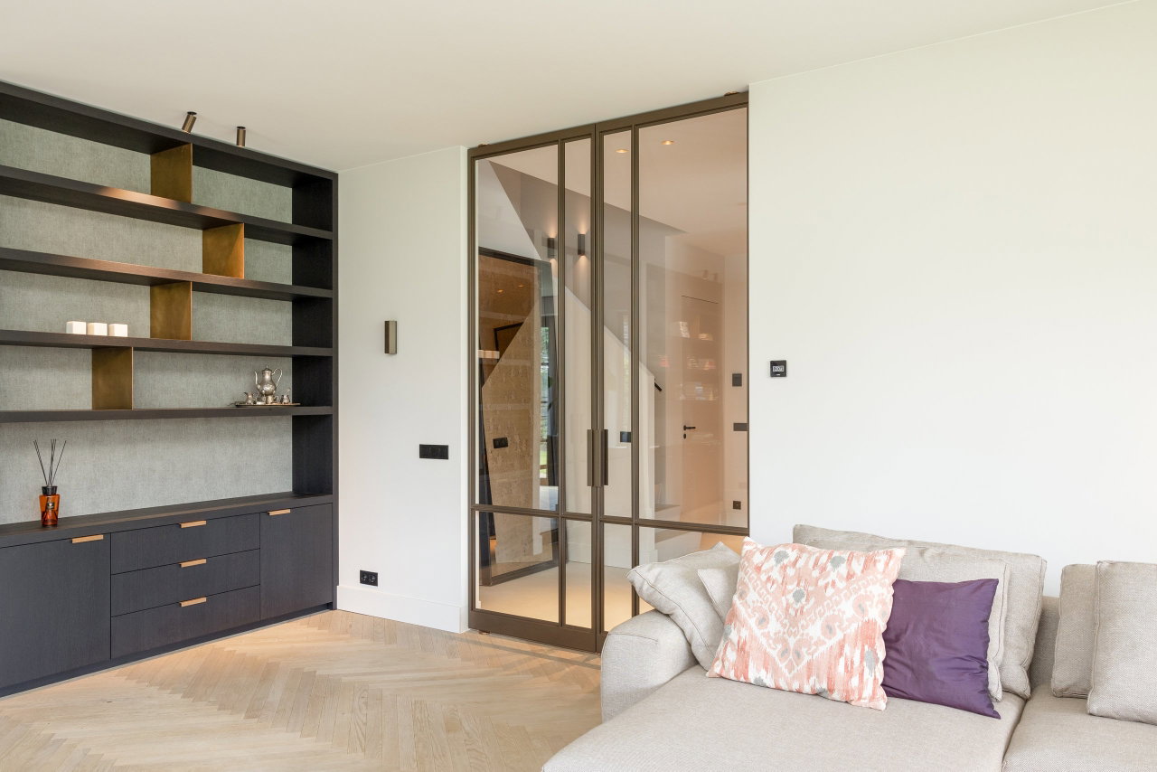 Steel and glass pivot door in a private home in Bilthoven with FritsJurgens System M pivot hinge system inside