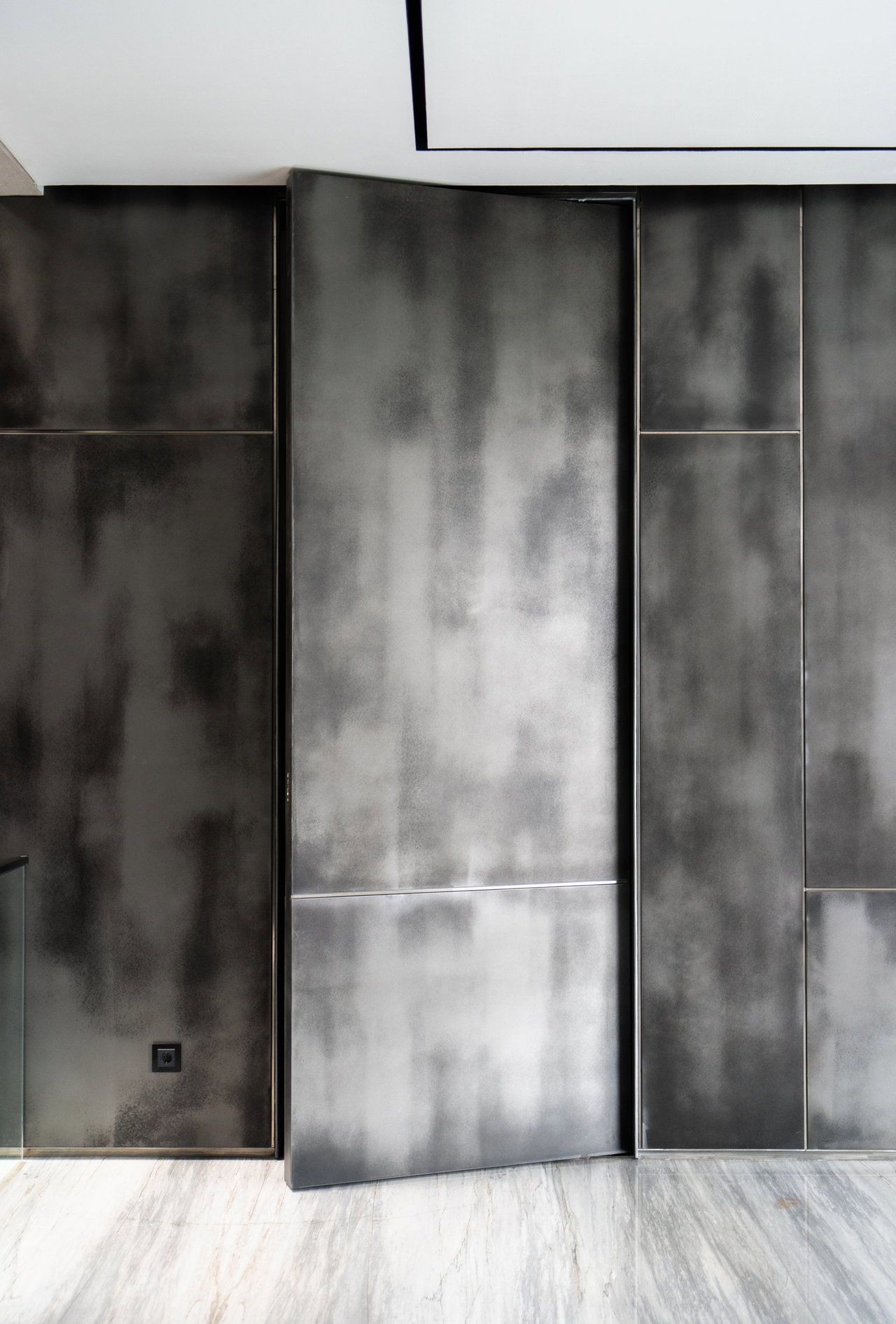 Aluminium pivot door in a private home in Jakarta with FritsJurgens System M+ pivot hinge system inside