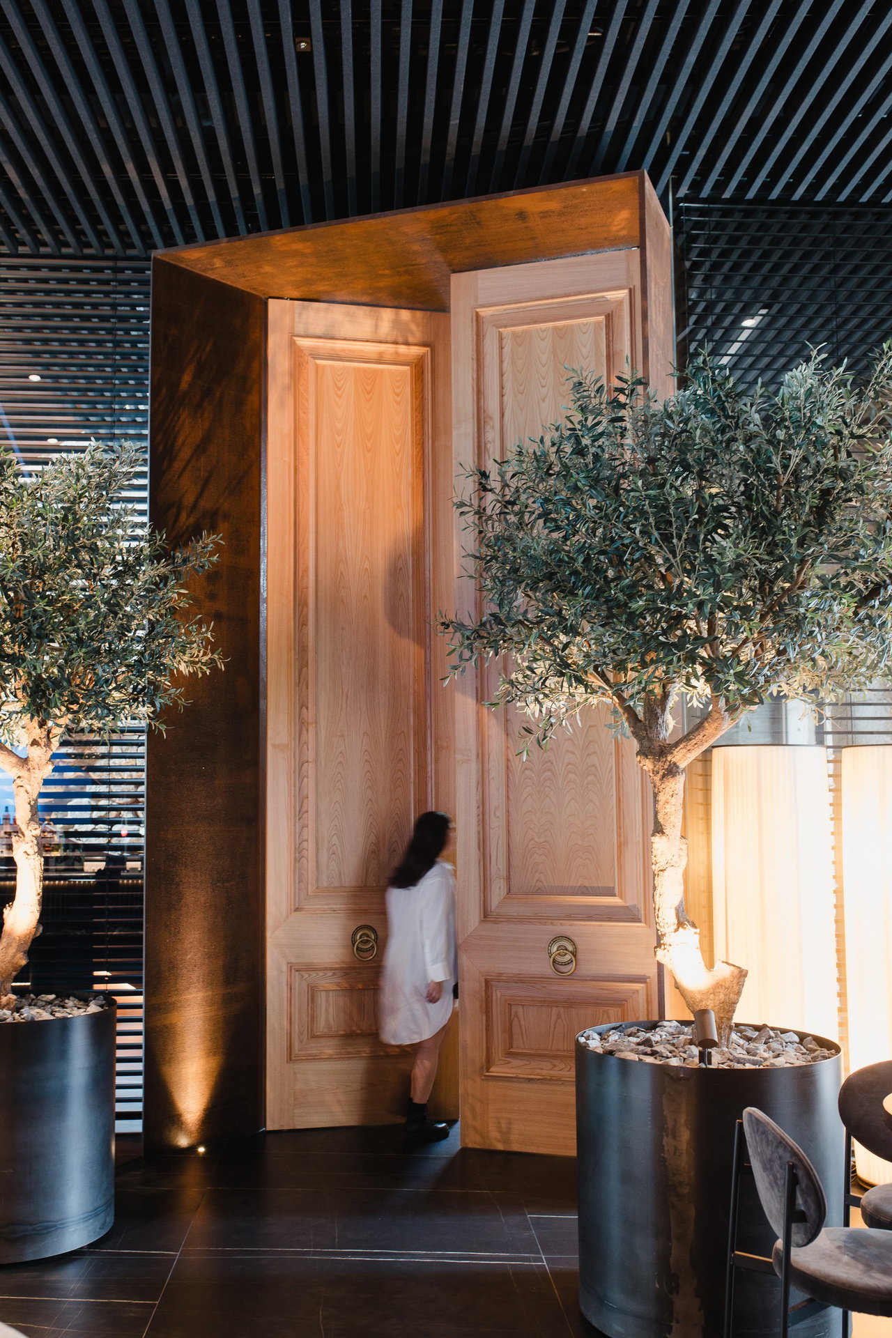 Pivottür aus Holz in einem Restaurant in Vigo mit FritsJurgens System M+ Pivot-Scharniersystem im Inneren