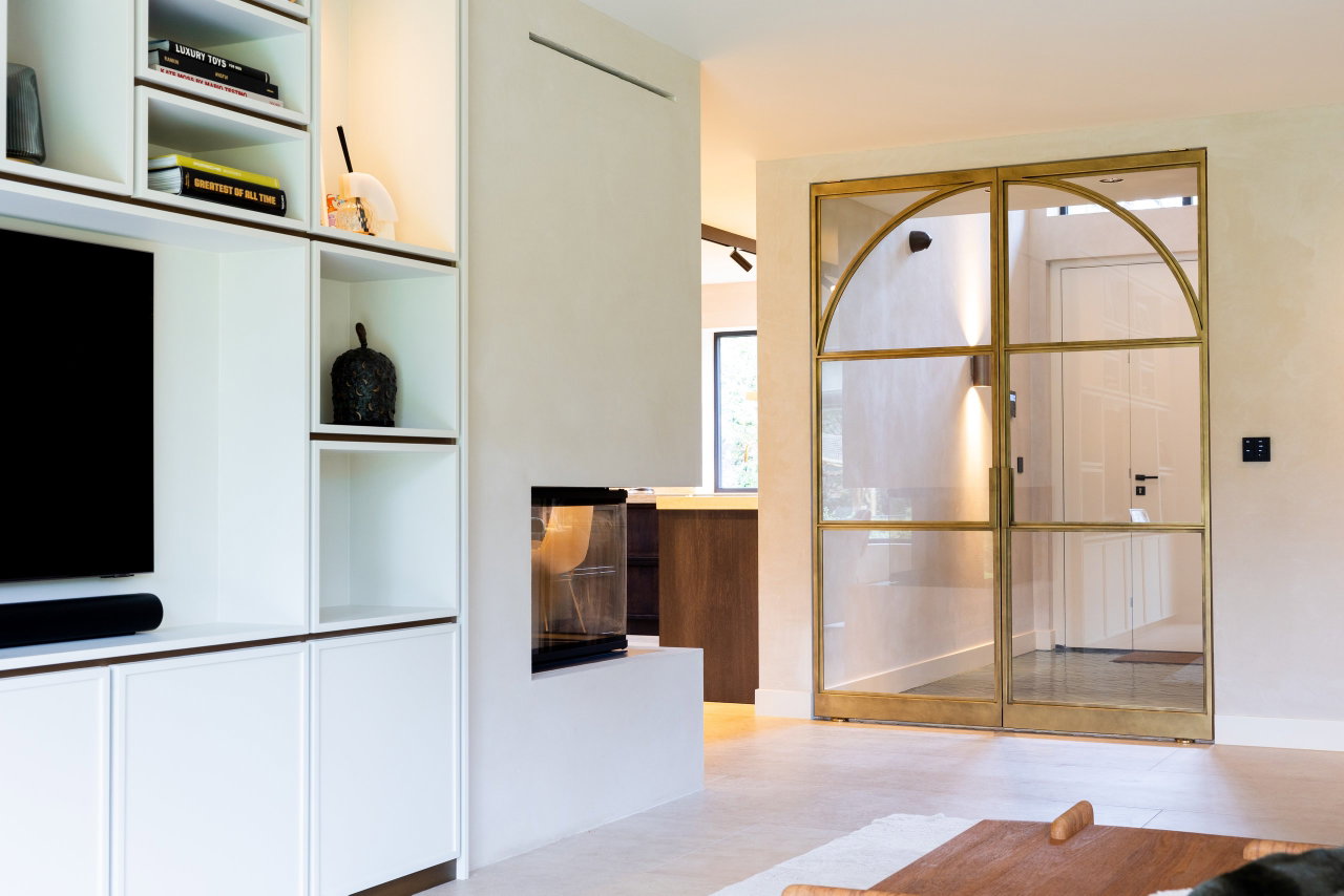 Steel and glass pivot door in a private home in Huizen with FritsJurgens System M pivot hinge system inside