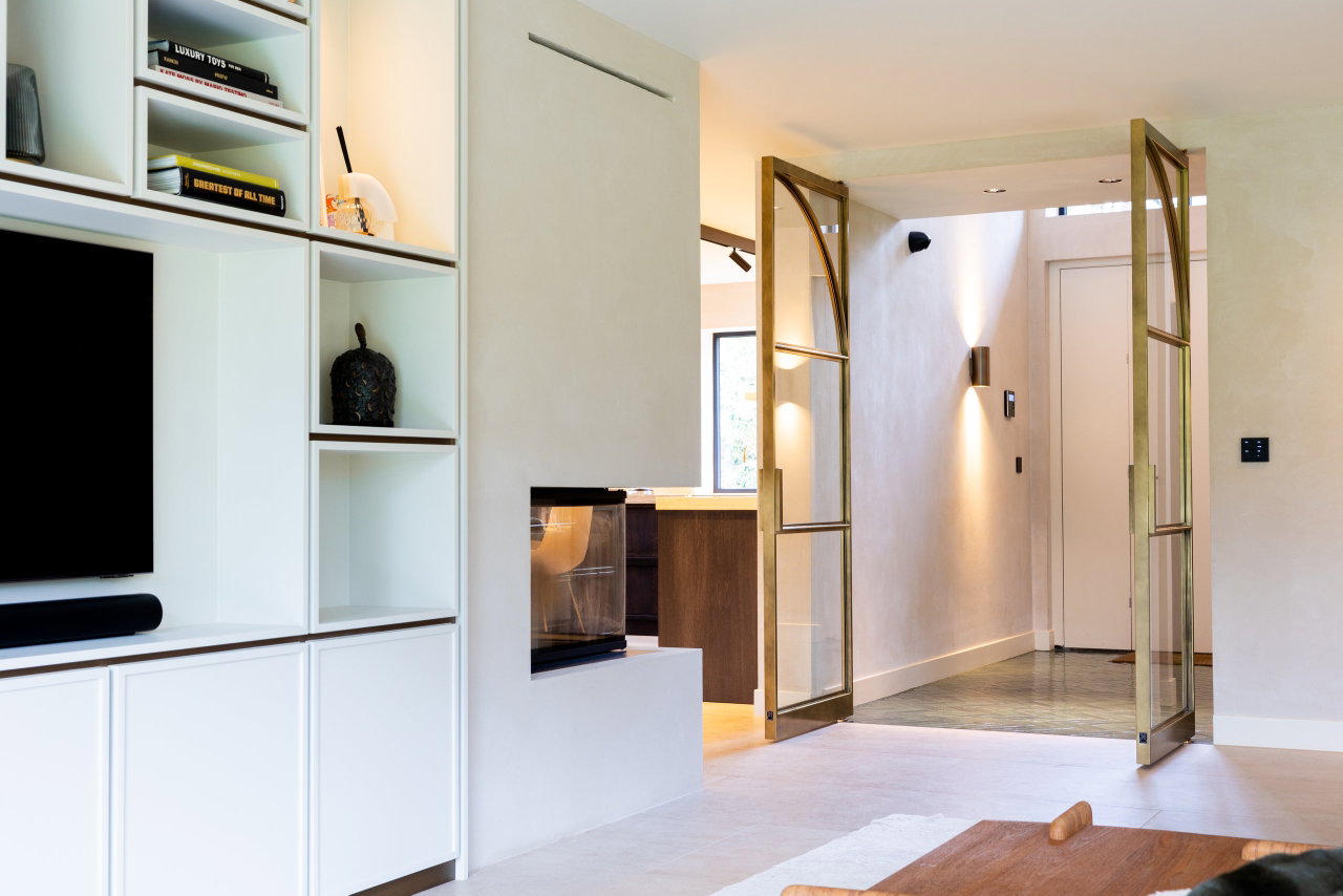 Steel and glass pivot door in a private home in Huizen with FritsJurgens System M pivot hinge system inside
