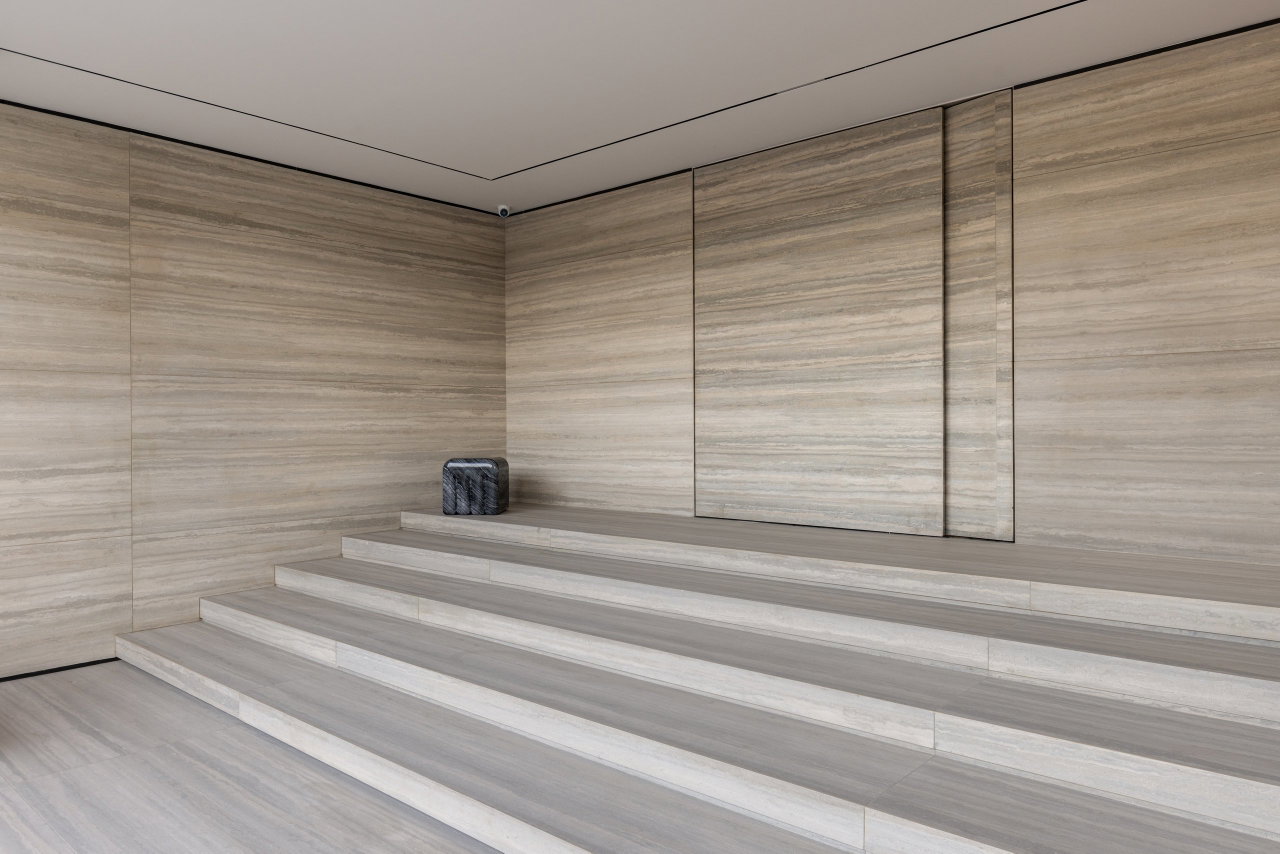 Stone pivot door in an office in Gurgaon with FritsJurgens System M+ pivot hinge system inside