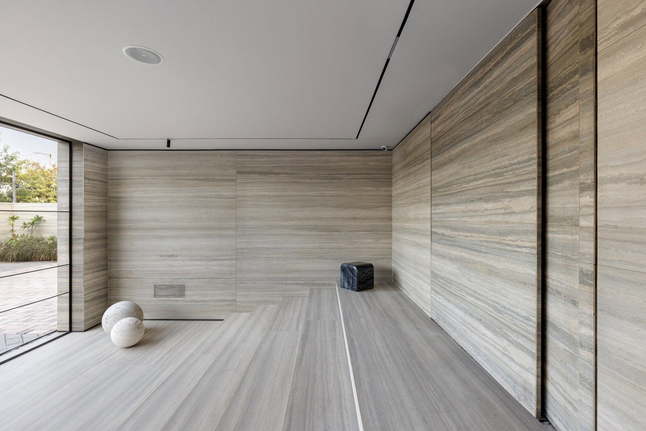 Stone pivot door in an office in Gurgaon with FritsJurgens System M+ pivot hinge system inside
