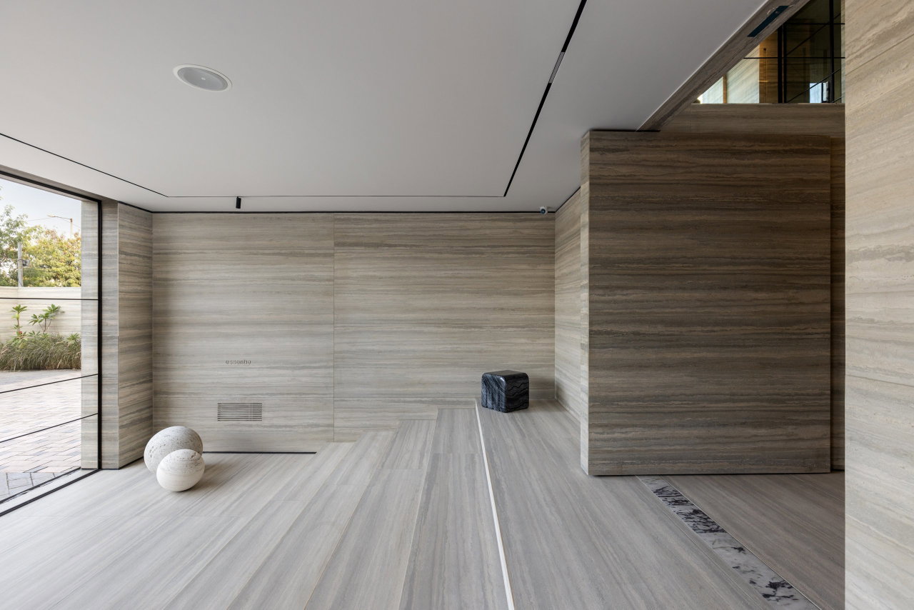 Stone pivot door in an office in Gurgaon with FritsJurgens System M+ pivot hinge system inside