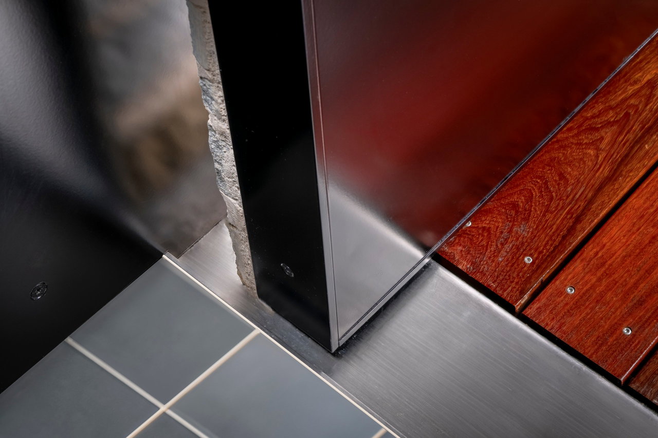 Stone pivot door in a private home in Kitzbühel with FritsJurgens System M+ pivot hinge system inside
