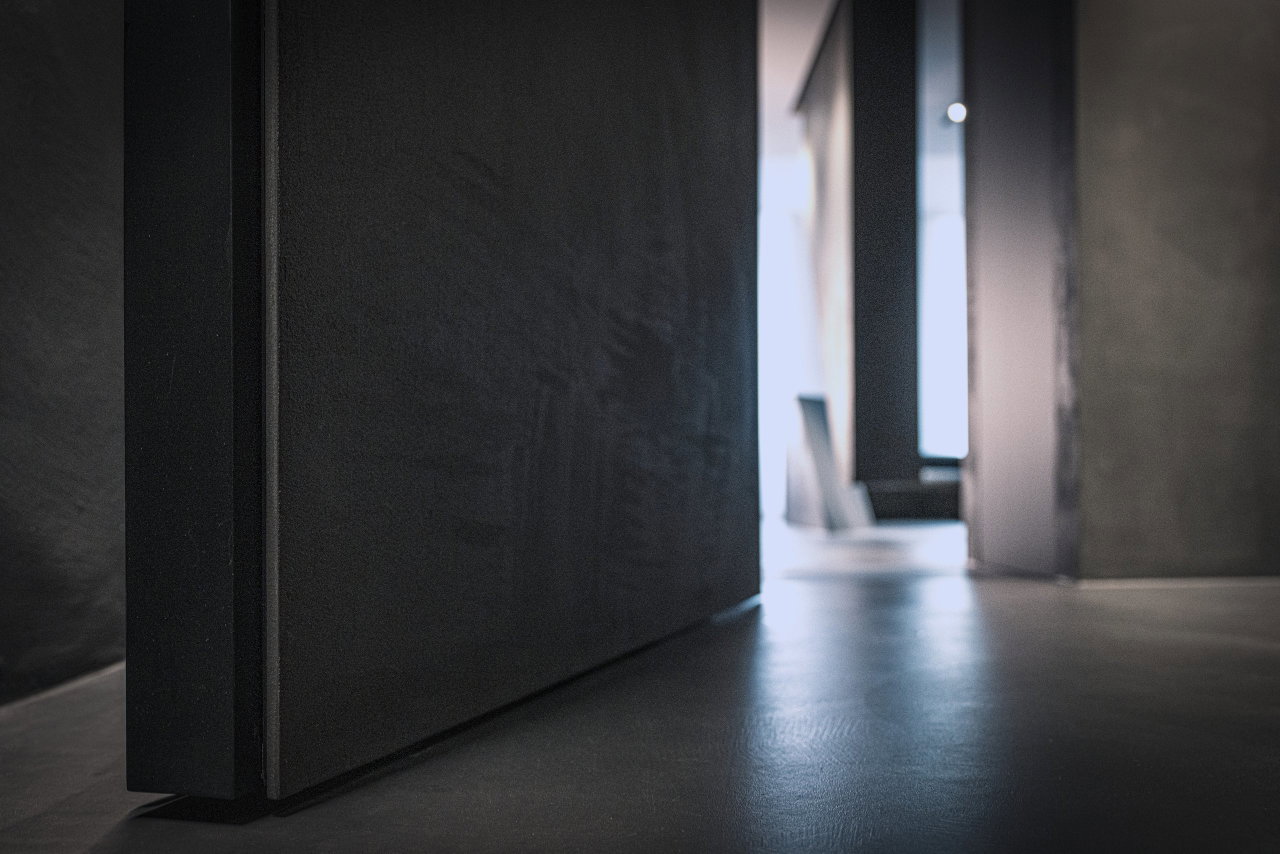 Stone pivot door in an office in Milan with FritsJurgens System M+ pivot hinge system inside
