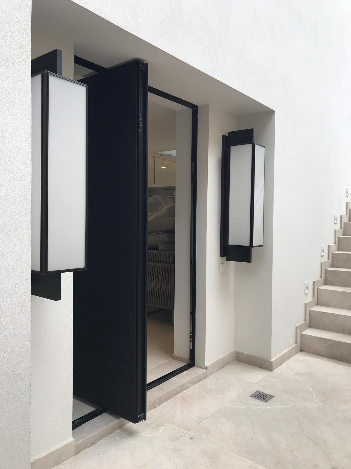Aluminium pivot door in a private home in Santa Ponça with FritsJurgens System M pivot hinge system inside