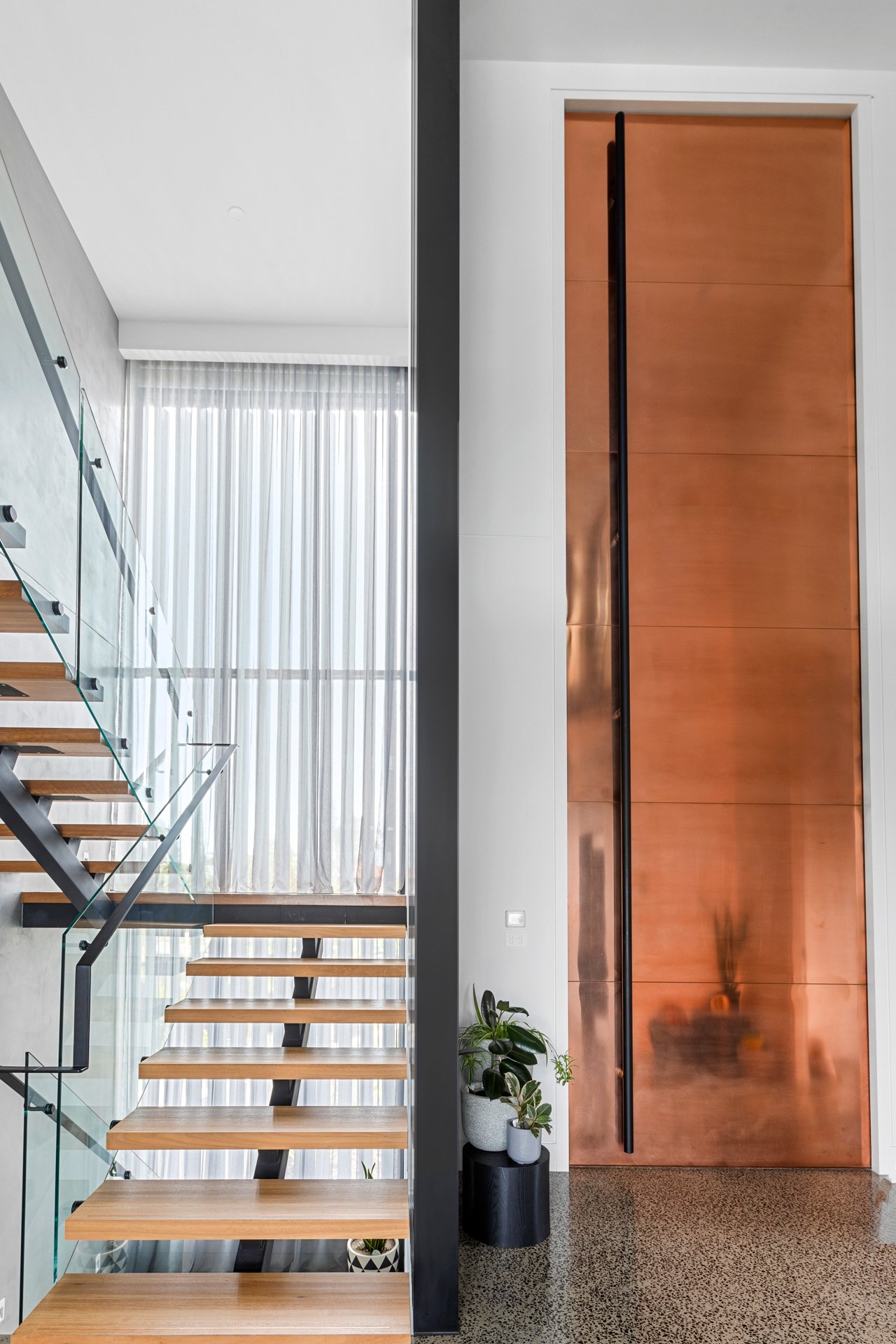 Steel pivot door in a private home in Melbourne with FritsJurgens System M+ pivot hinge system inside