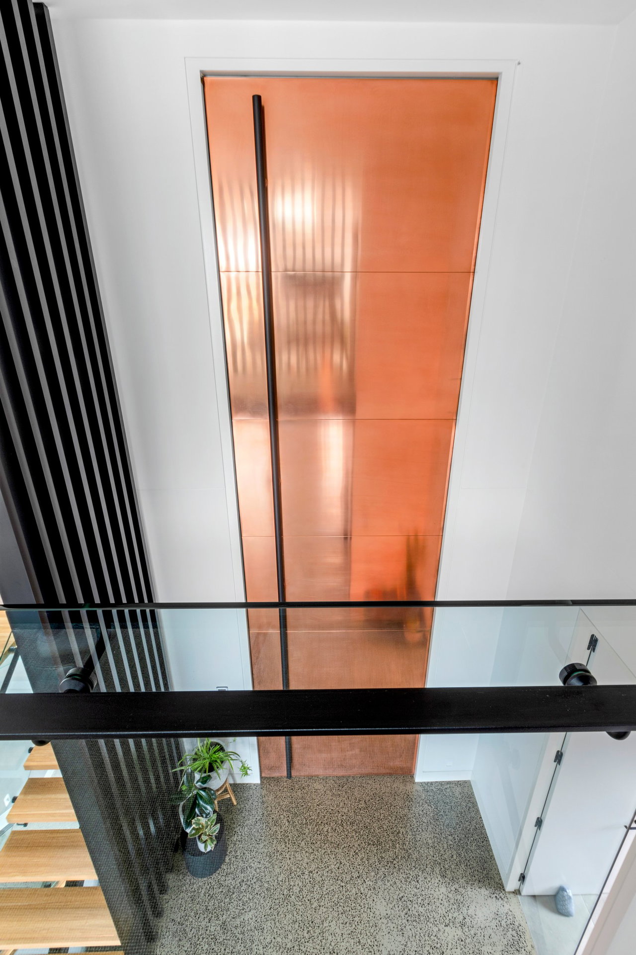Steel pivot door in a private home in Melbourne with FritsJurgens System M+ pivot hinge system inside
