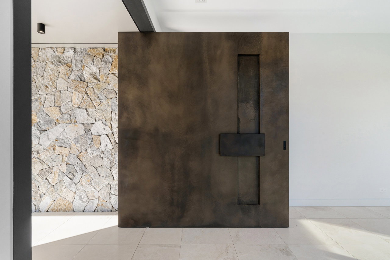 Wooden pivot door in a private home in Sydney with FritsJurgens System M+ pivot hinge system inside