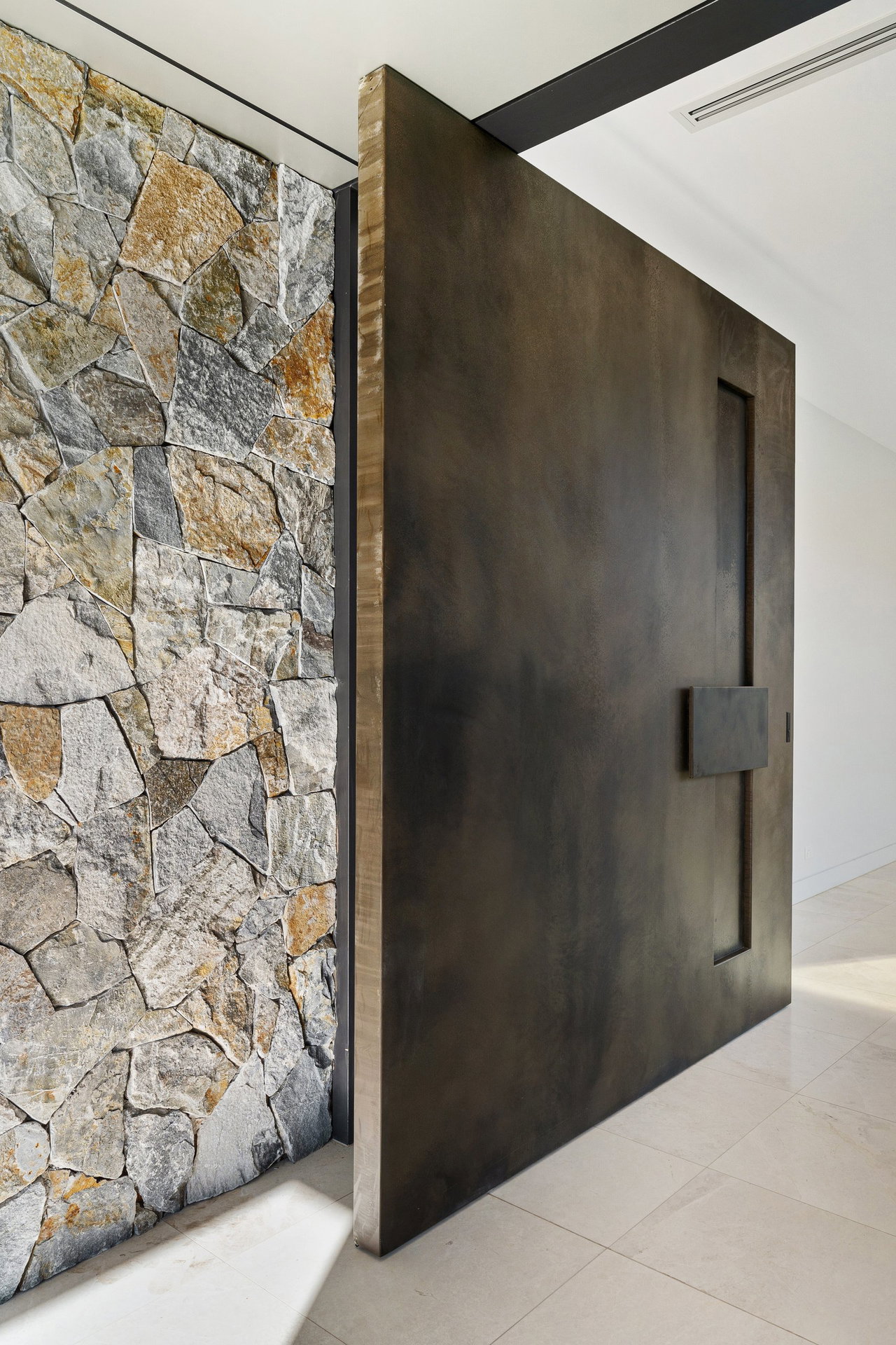 Wooden pivot door in a private home in Sydney with FritsJurgens System M+ pivot hinge system inside