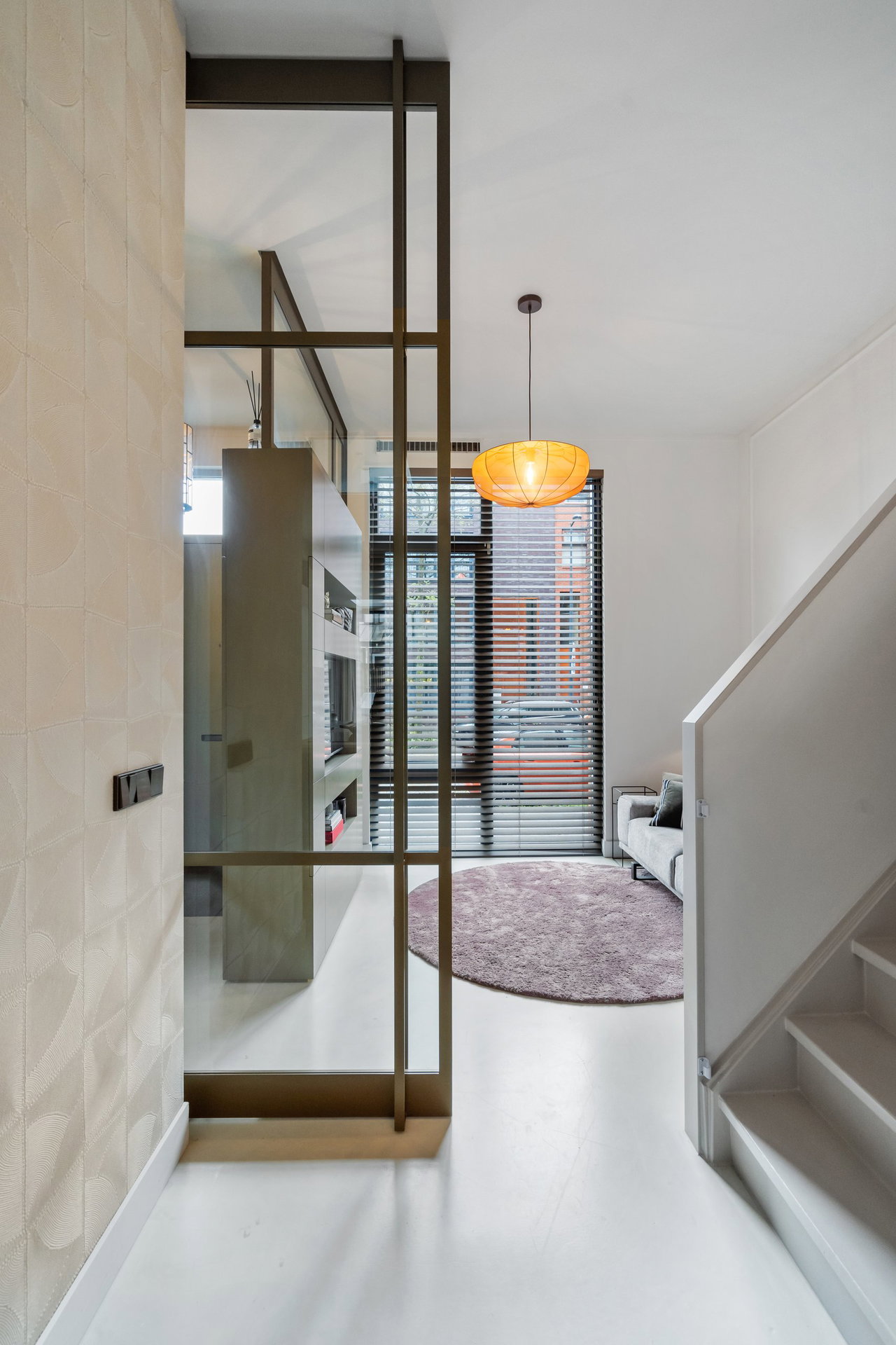 Steel and glass pivot door in a private home in Amsterdam with FritsJurgens System M pivot hinge system inside