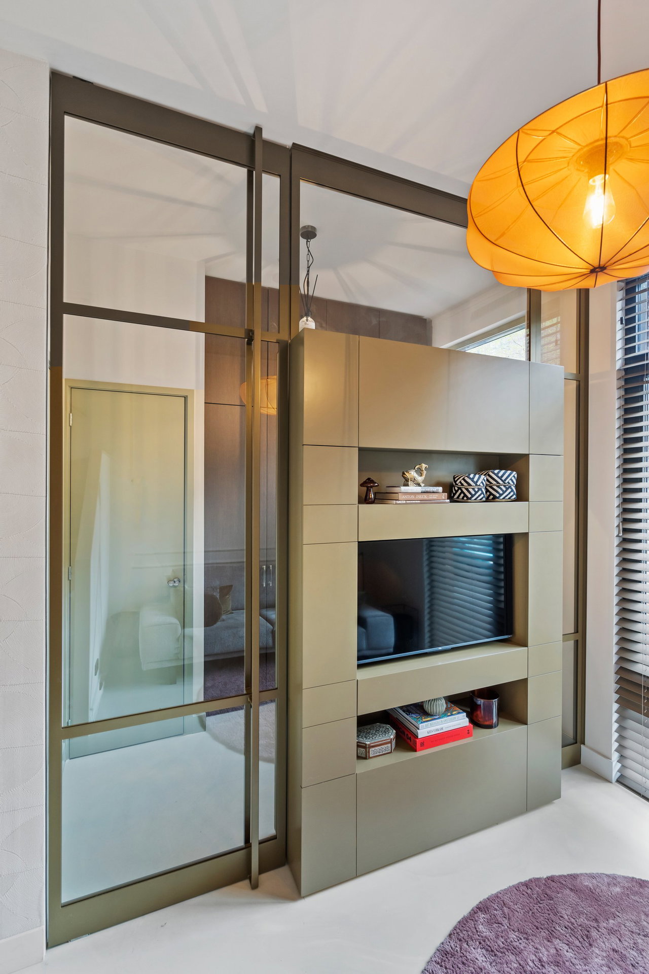 Steel and glass pivot door in a private home in Amsterdam with FritsJurgens System M pivot hinge system inside