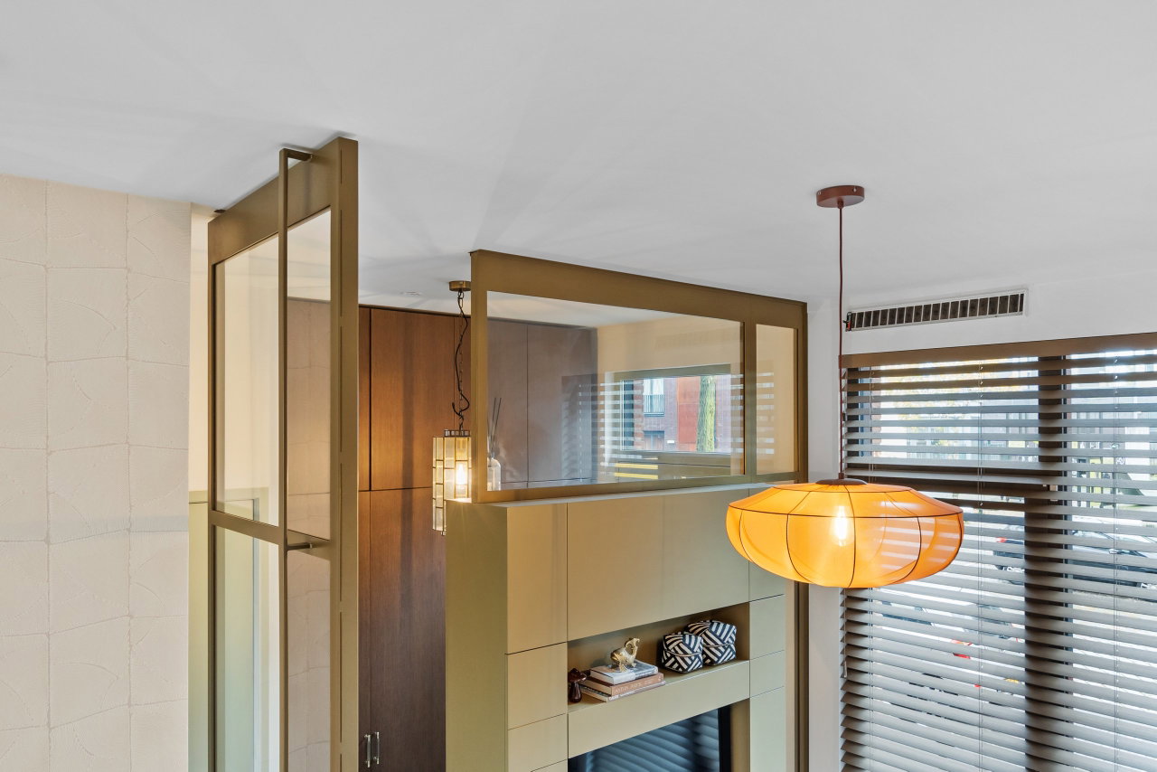 Steel and glass pivot door in a private home in Amsterdam with FritsJurgens System M pivot hinge system inside