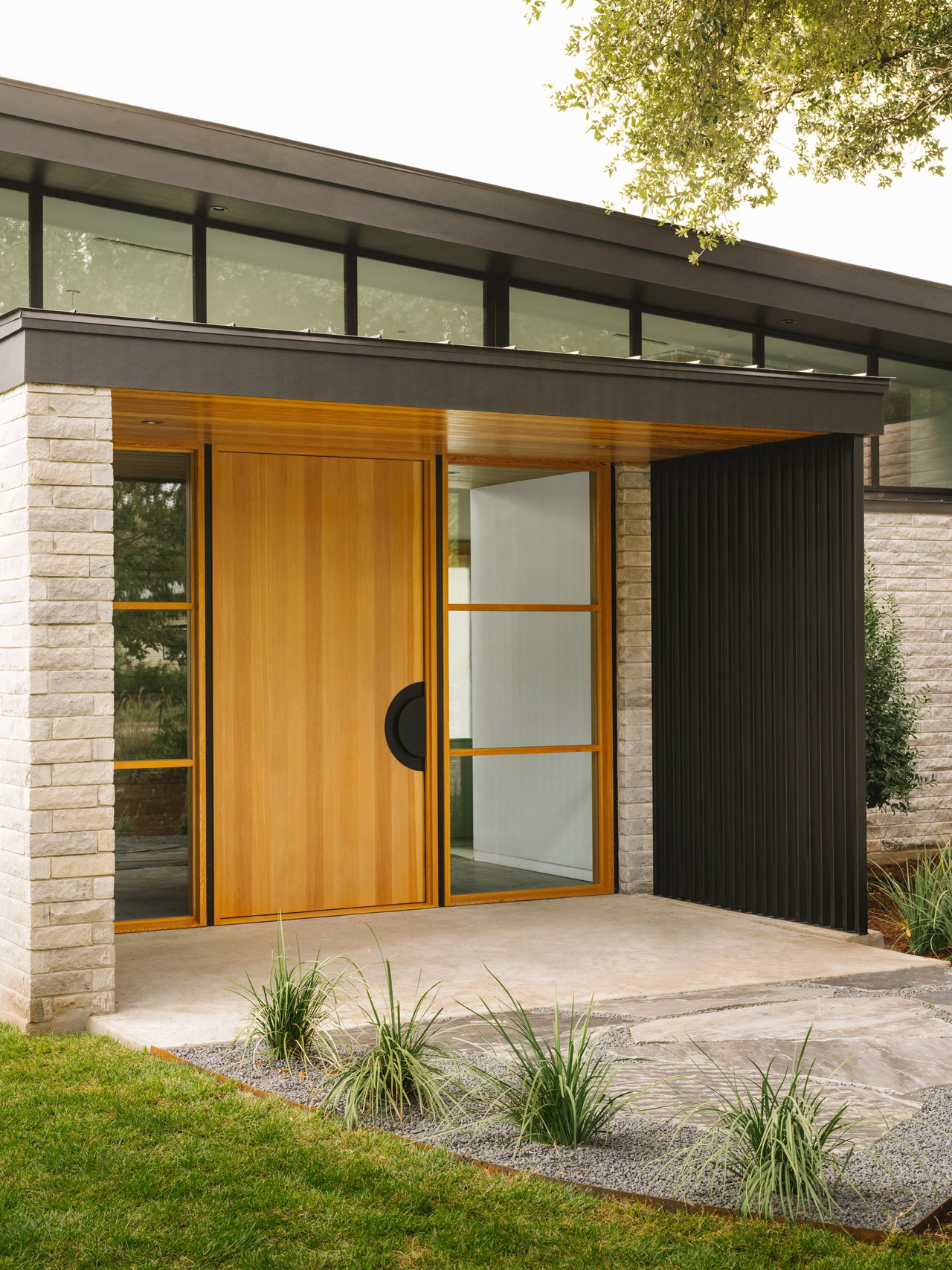 Wooden pivot door in a private home in Austin with FritsJurgens System M+ pivot hinge system inside