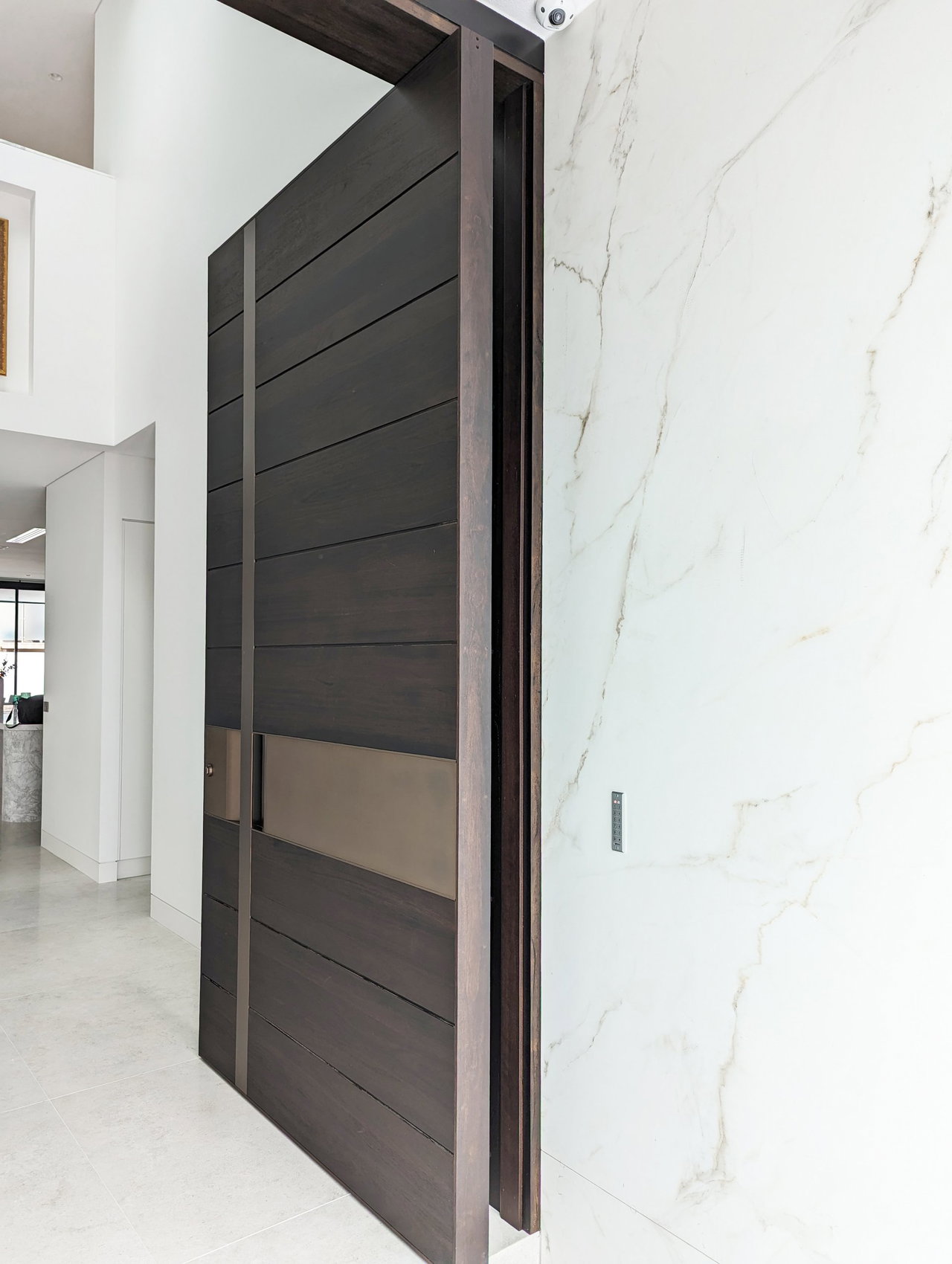 Wooden pivot door in a private home in Sydney with FritsJurgens System M+ pivot hinge system inside