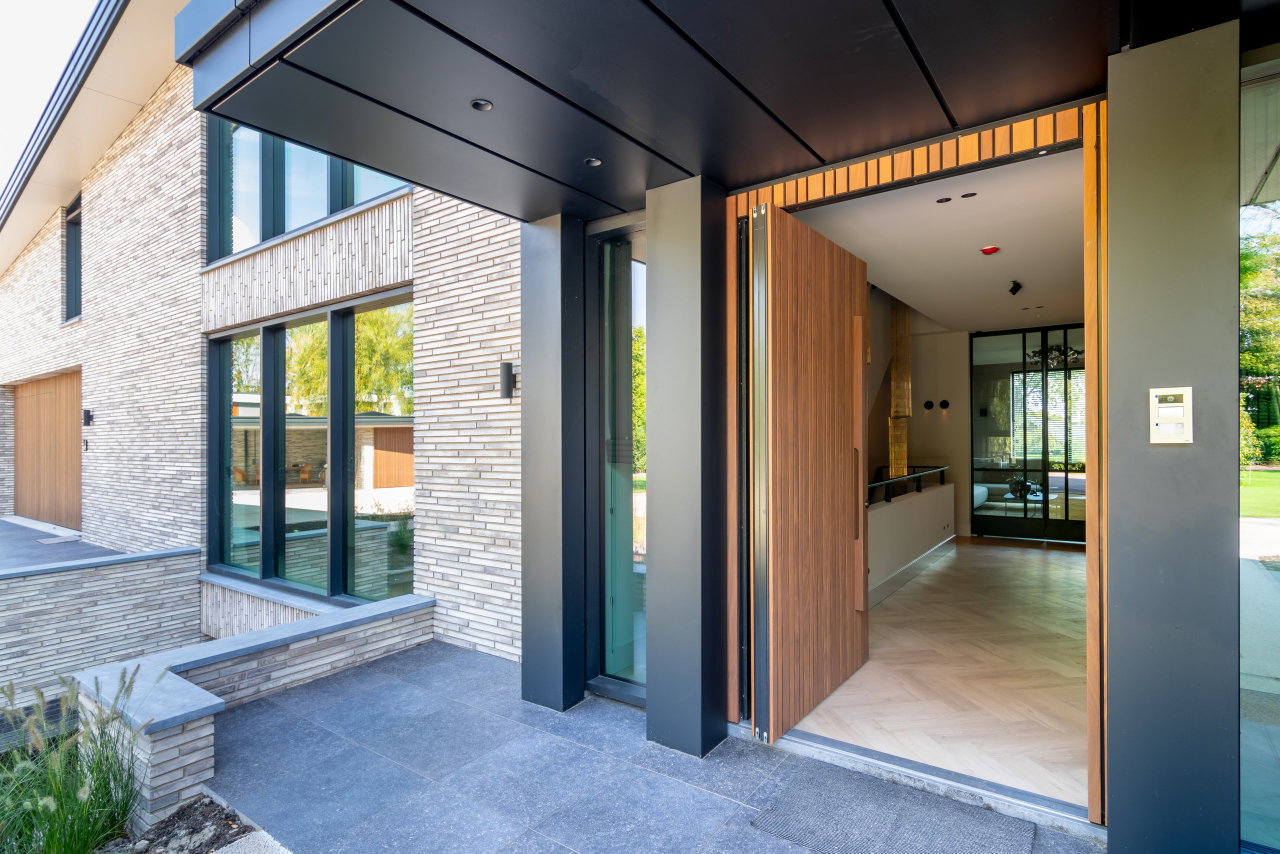 Wooden pivot door in a private home with FritsJurgens System 3 pivot hinge system inside