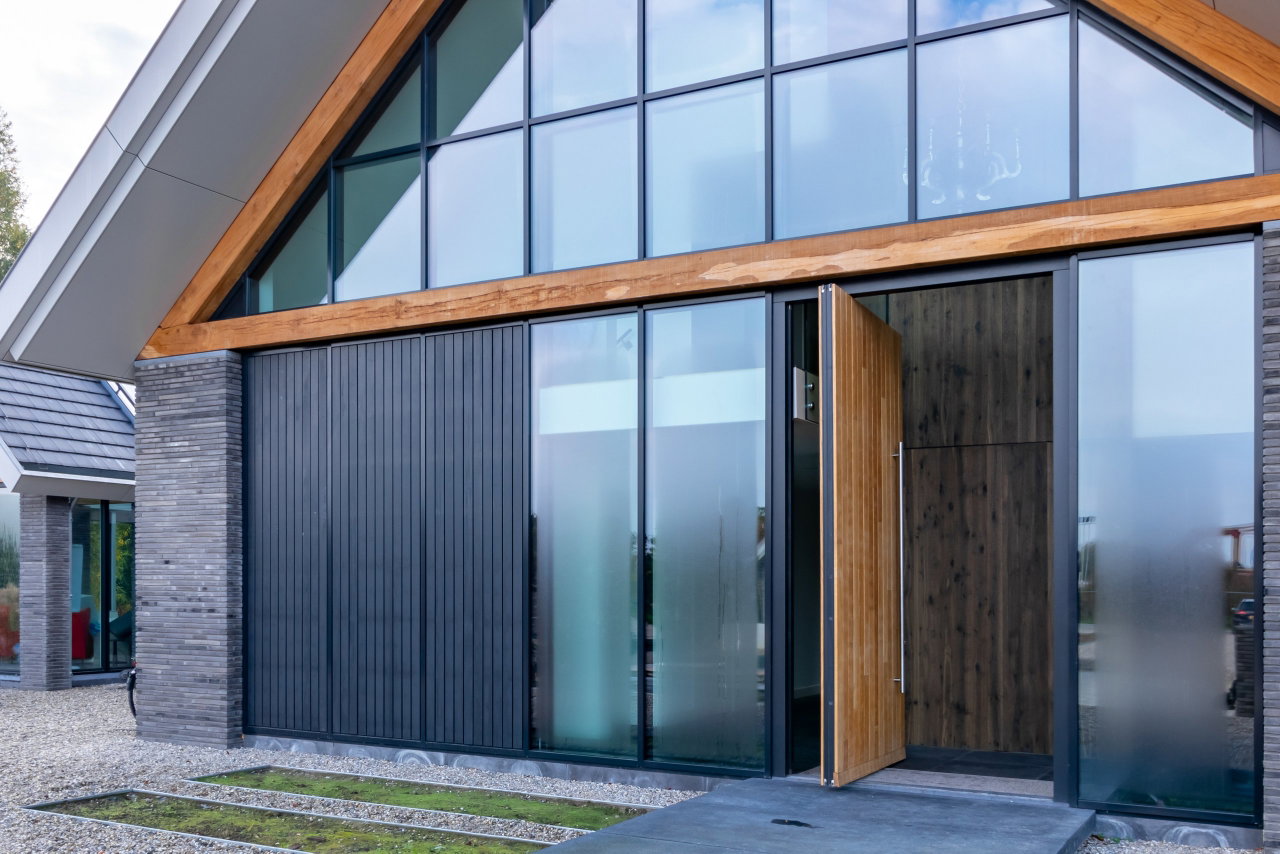 Wooden pivot door in a private home with FritsJurgens System One pivot hinge system inside