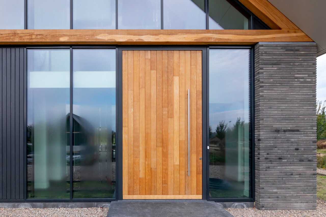 Wooden pivot door in a private home with FritsJurgens System One pivot hinge system inside