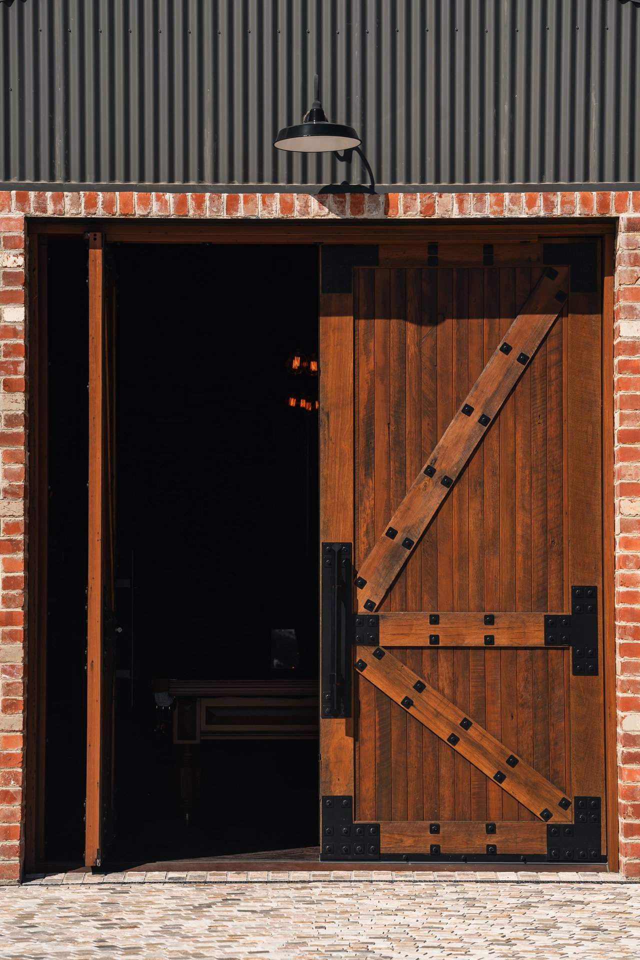 Wooden pivot door in a commercial building in Canberra with FritsJurgens System M+ pivot hinge system inside