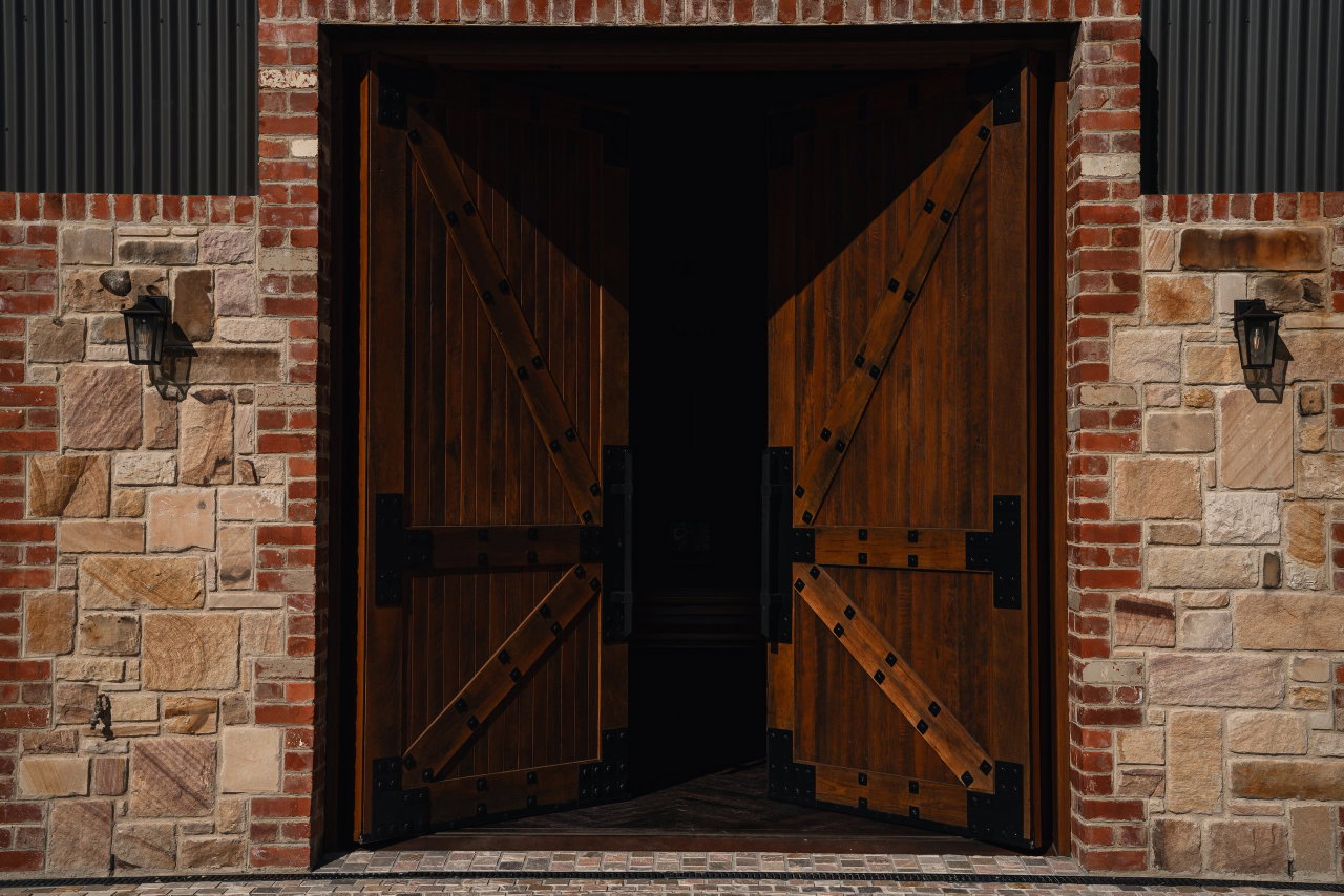 Wooden pivot door in a commercial building in Canberra with FritsJurgens System M+ pivot hinge system inside