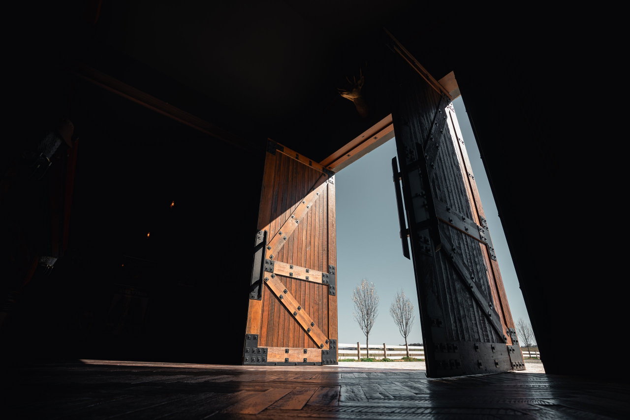 Wooden pivot door in a commercial building in Canberra with FritsJurgens System M+ pivot hinge system inside
