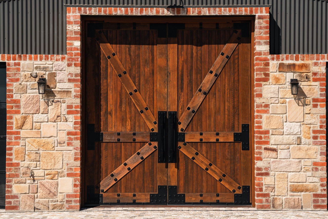 Wooden pivot door in a commercial building in Canberra with FritsJurgens System M+ pivot hinge system inside