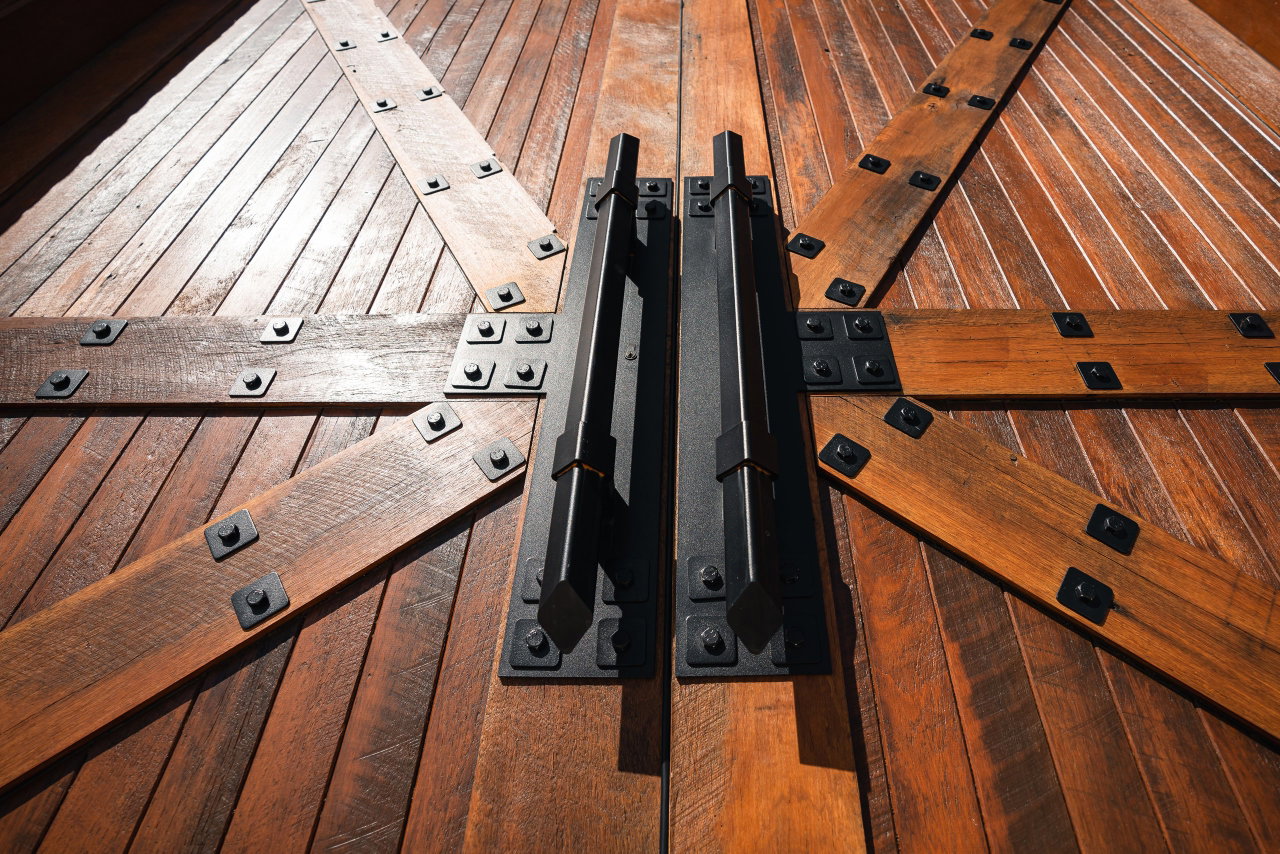 Wooden pivot door in a commercial building in Canberra with FritsJurgens System M+ pivot hinge system inside