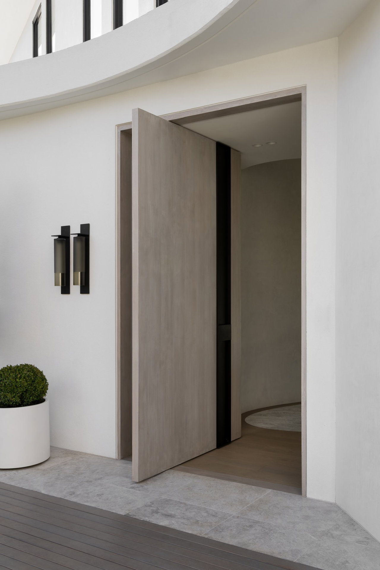 Wooden pivot door in a private home in Melbourne with FritsJurgens System M+ pivot hinge system inside