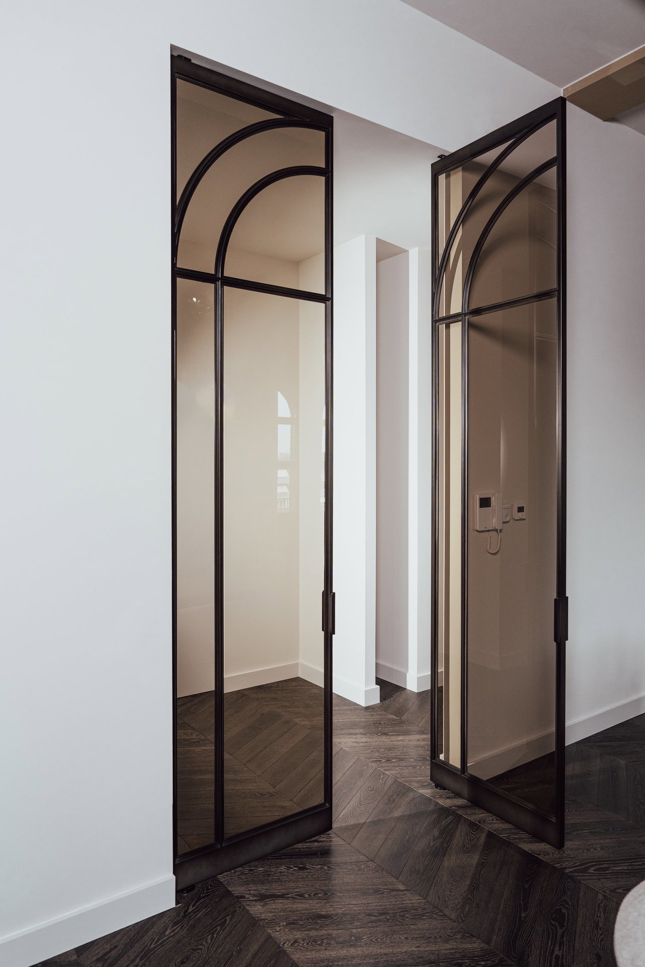 Steel and glass pivot door in a private home in Eindhoven with FritsJurgens System M+ pivot hinge system inside