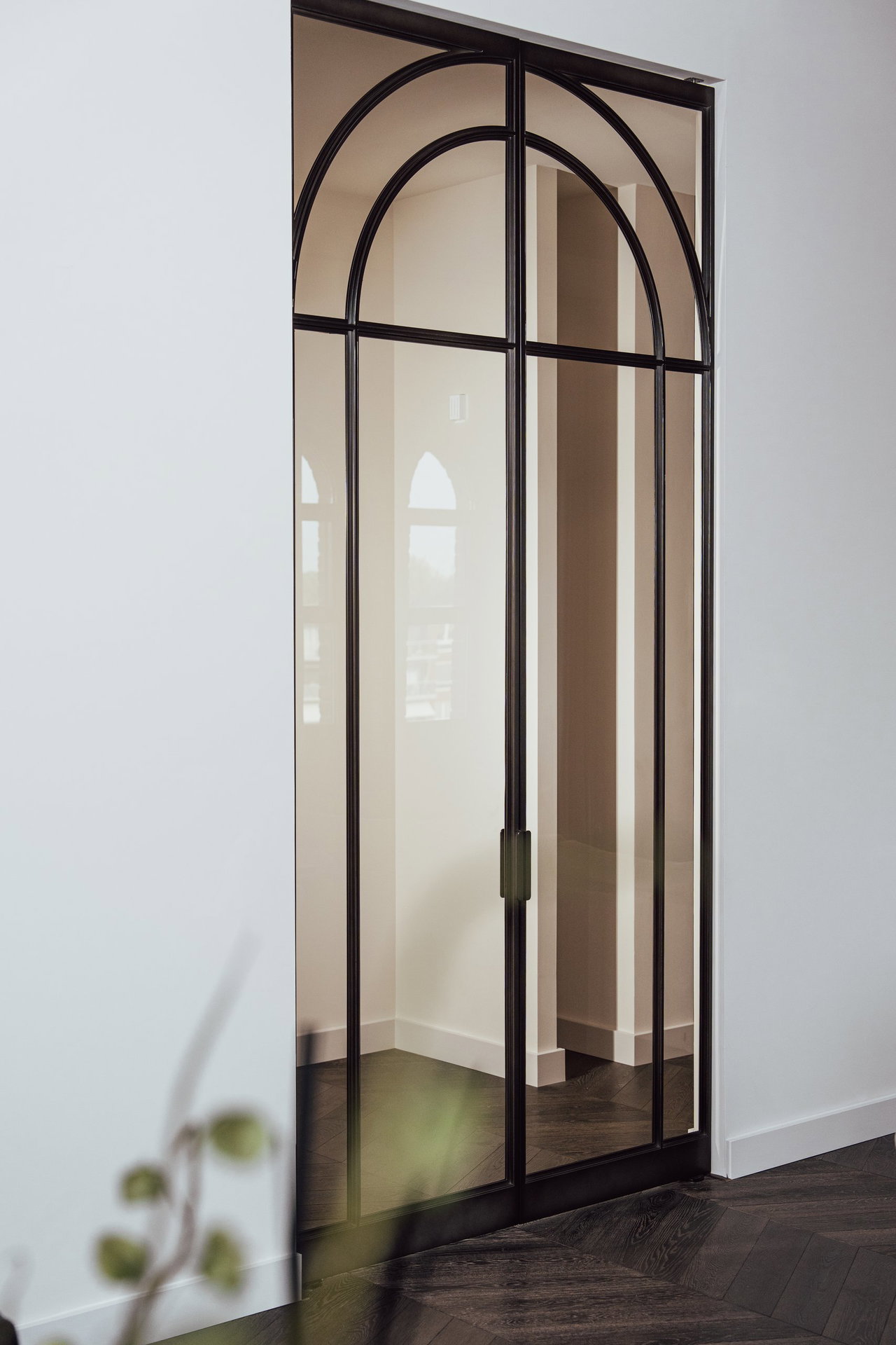 Steel and glass pivot door in a private home in Eindhoven with FritsJurgens System M+ pivot hinge system inside