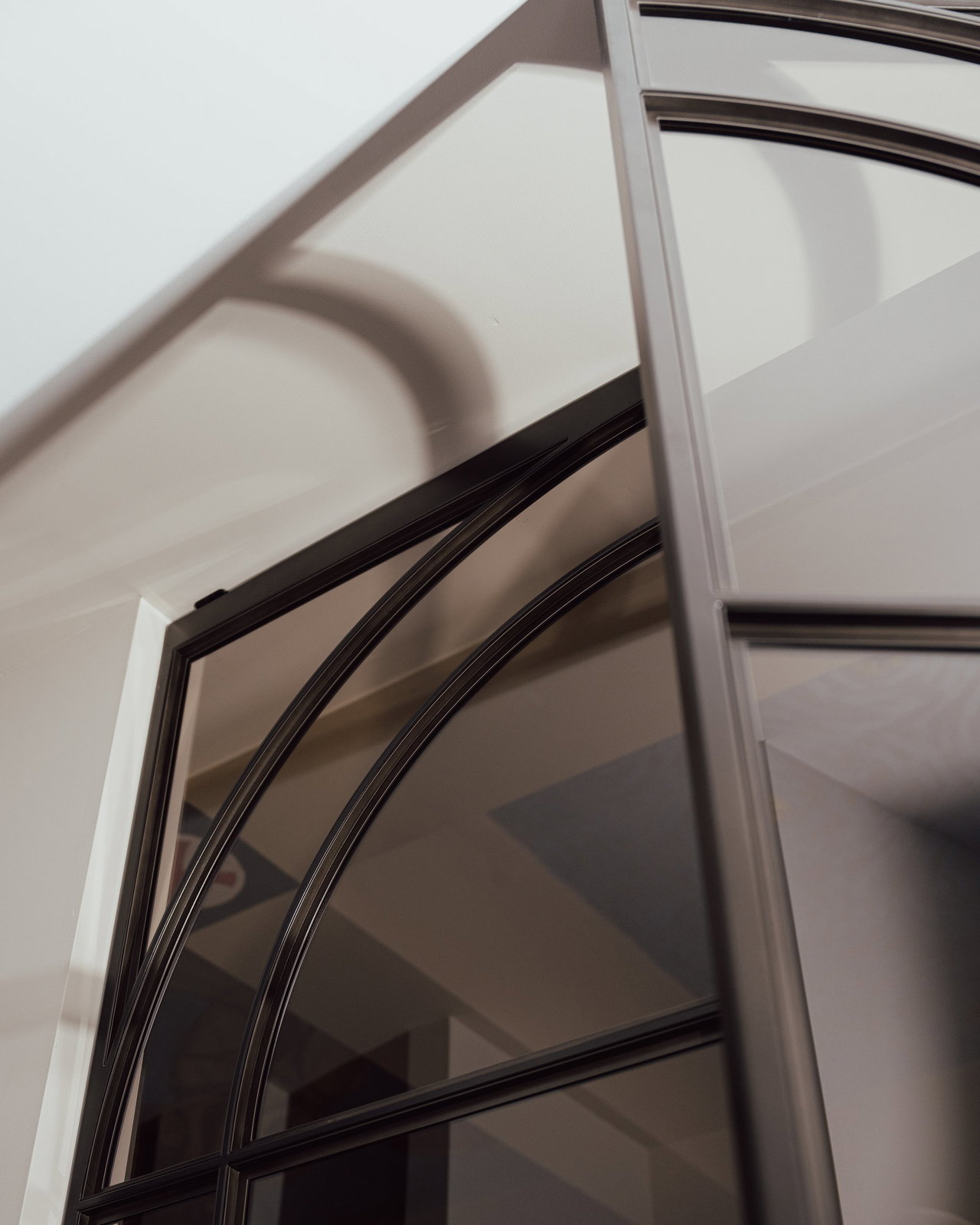 Steel and glass pivot door in a private home in Eindhoven with FritsJurgens System M+ pivot hinge system inside