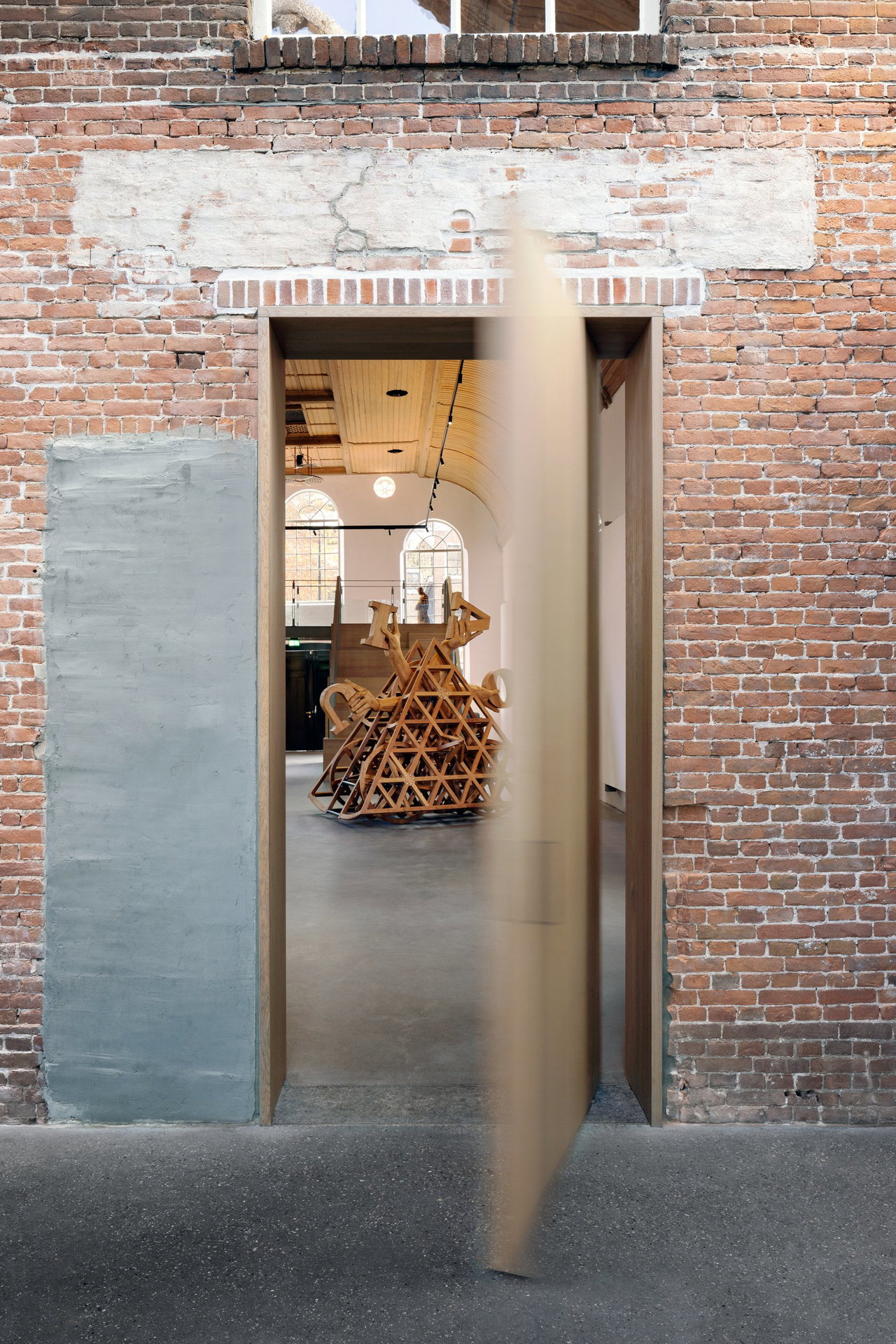 Wooden pivot door in a public building in Dordrecht with FritsJurgens System M+ pivot hinge system inside