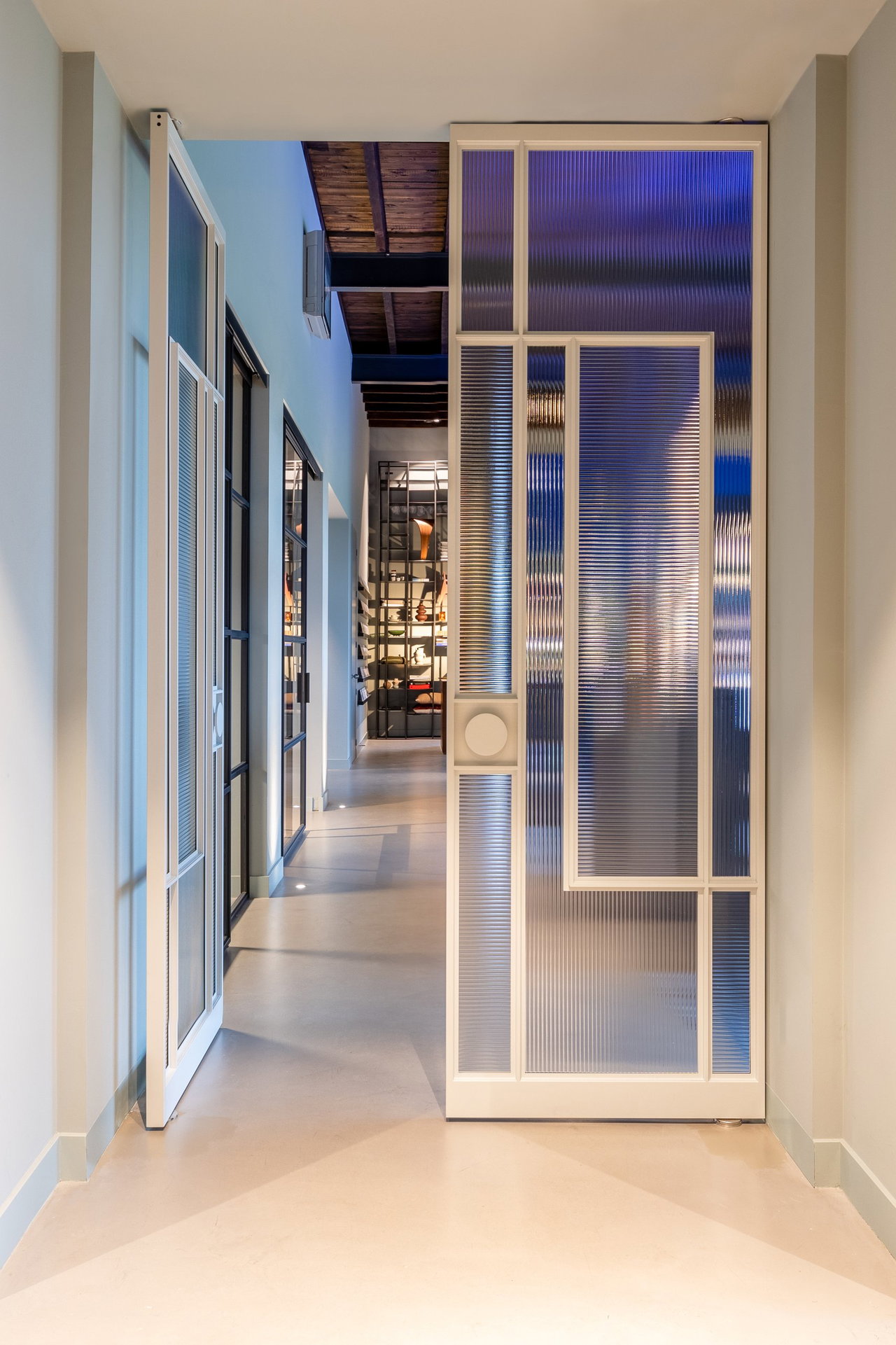 Steel and glass pivot door in an office in Oosterbeek with FritsJurgens System M+ pivot hinge system inside