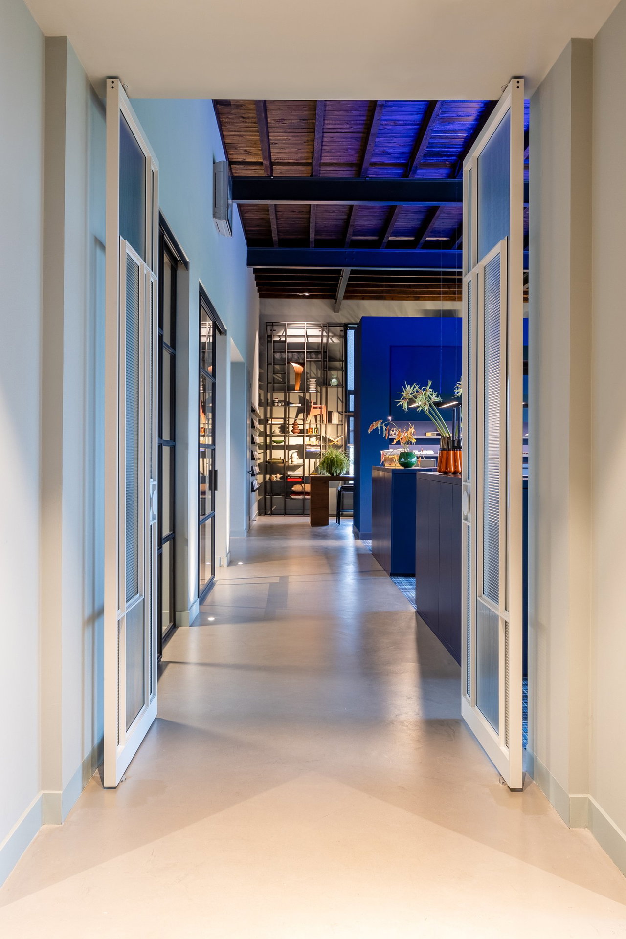 Steel and glass pivot door in an office in Oosterbeek with FritsJurgens System M+ pivot hinge system inside