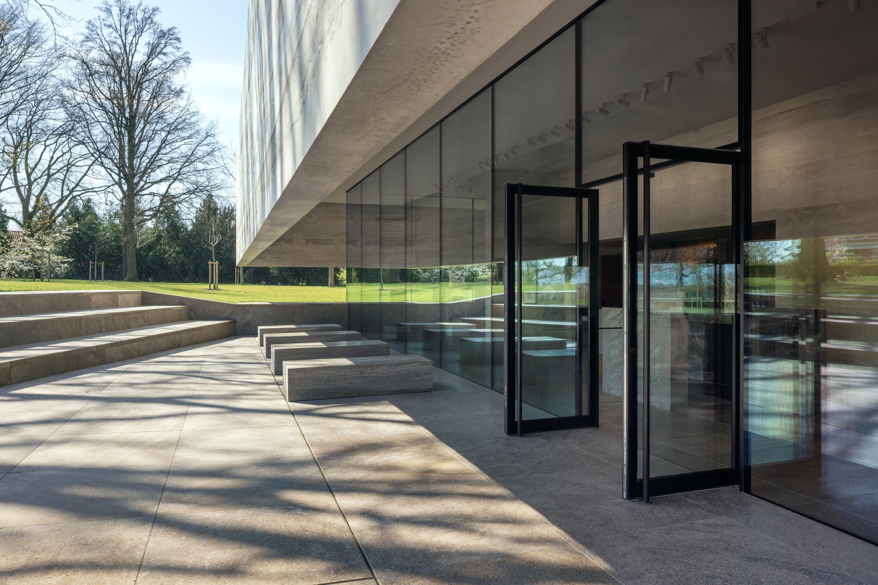 Steel and glass pivot door at a public site in Margraten with FritsJurgens System M+ pivot hinge system inside