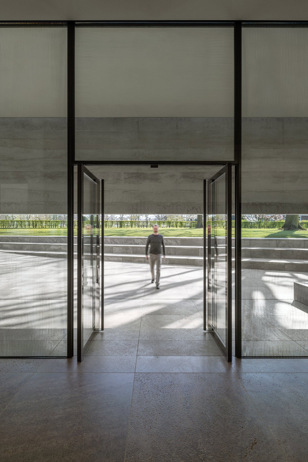 Steel and glass pivot door at a public site in Margraten with FritsJurgens System M+ pivot hinge system inside