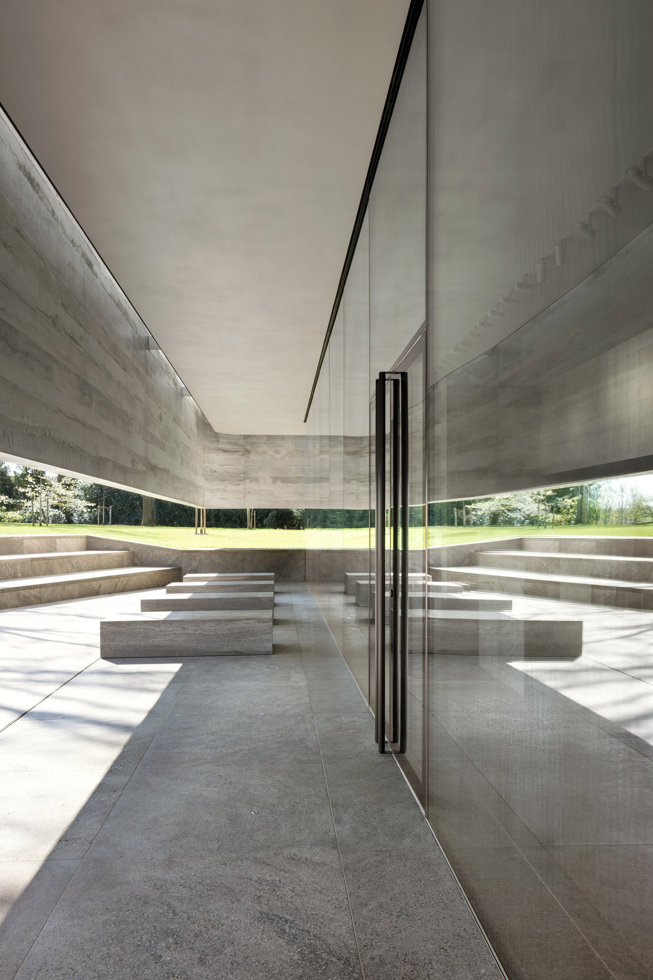 Steel and glass pivot door at a public site in Margraten with FritsJurgens System M+ pivot hinge system inside