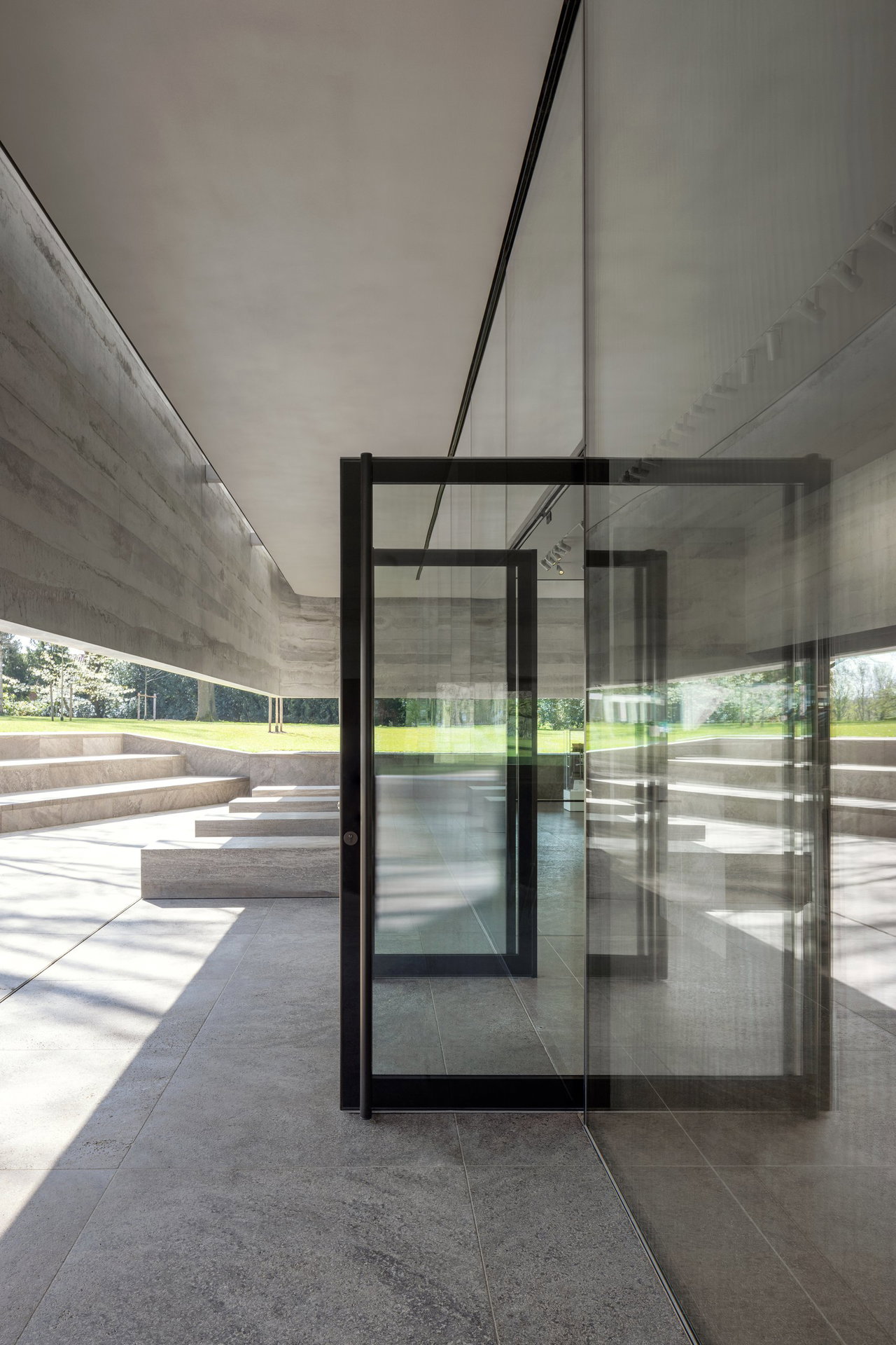 Steel and glass pivot door at a public site in Margraten with FritsJurgens System M+ pivot hinge system inside
