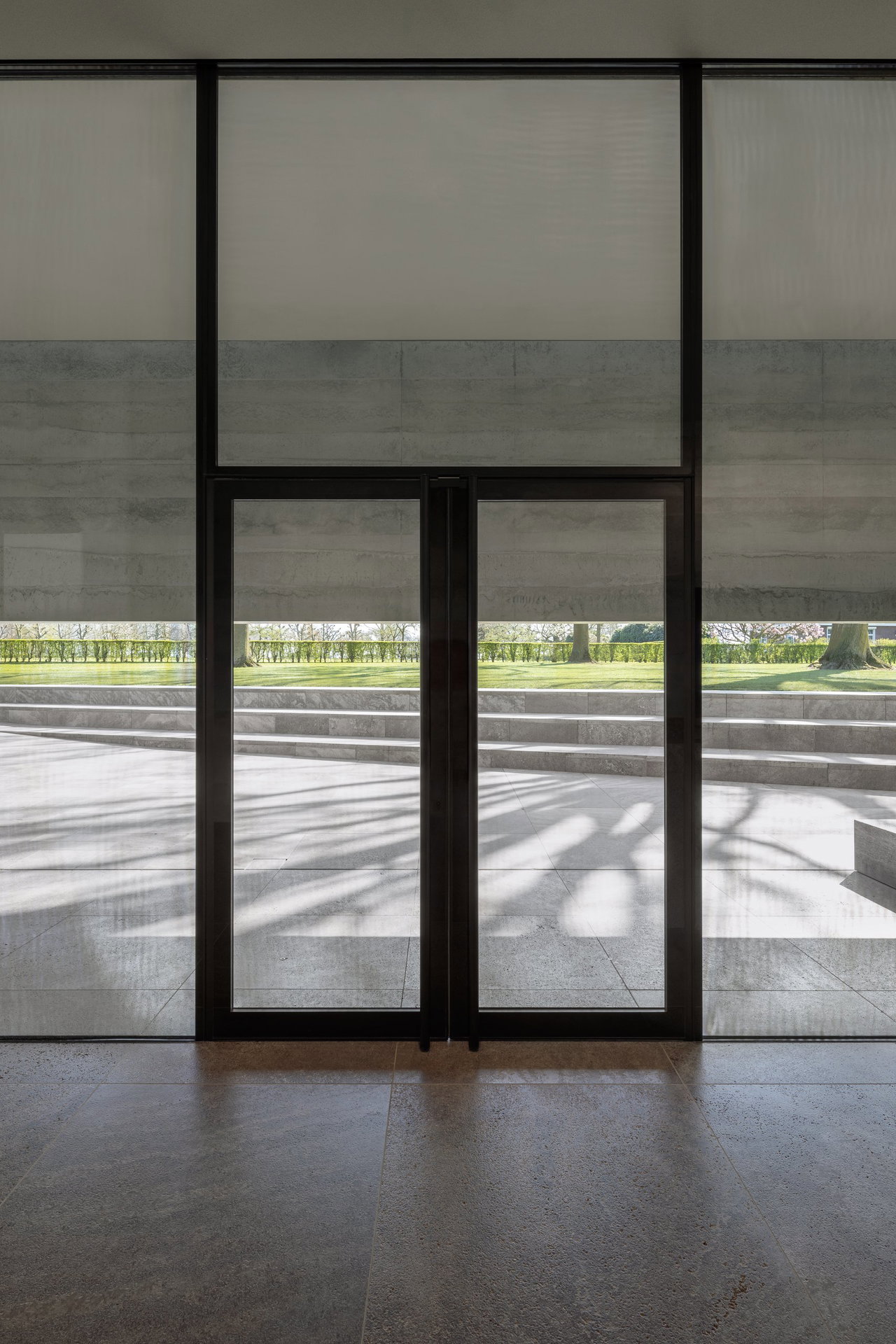 Steel and glass pivot door at a public site in Margraten with FritsJurgens System M+ pivot hinge system inside