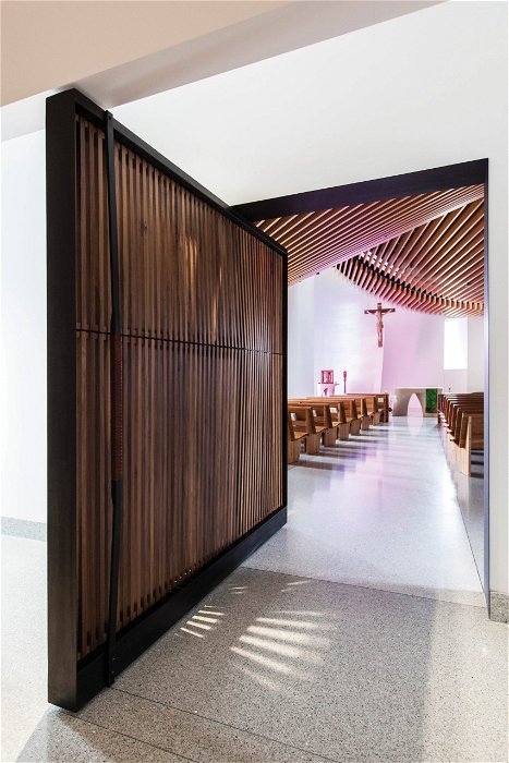 Modern church architecture pivot door with walnut slats - FritsJurgens pivot hinge