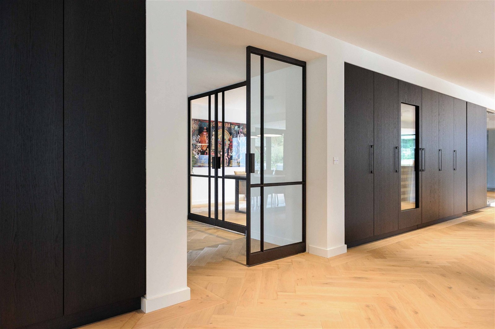 Multiple glass and steel pivot doors designed by Preferro - FritsJurgens pivot hinges Inside.