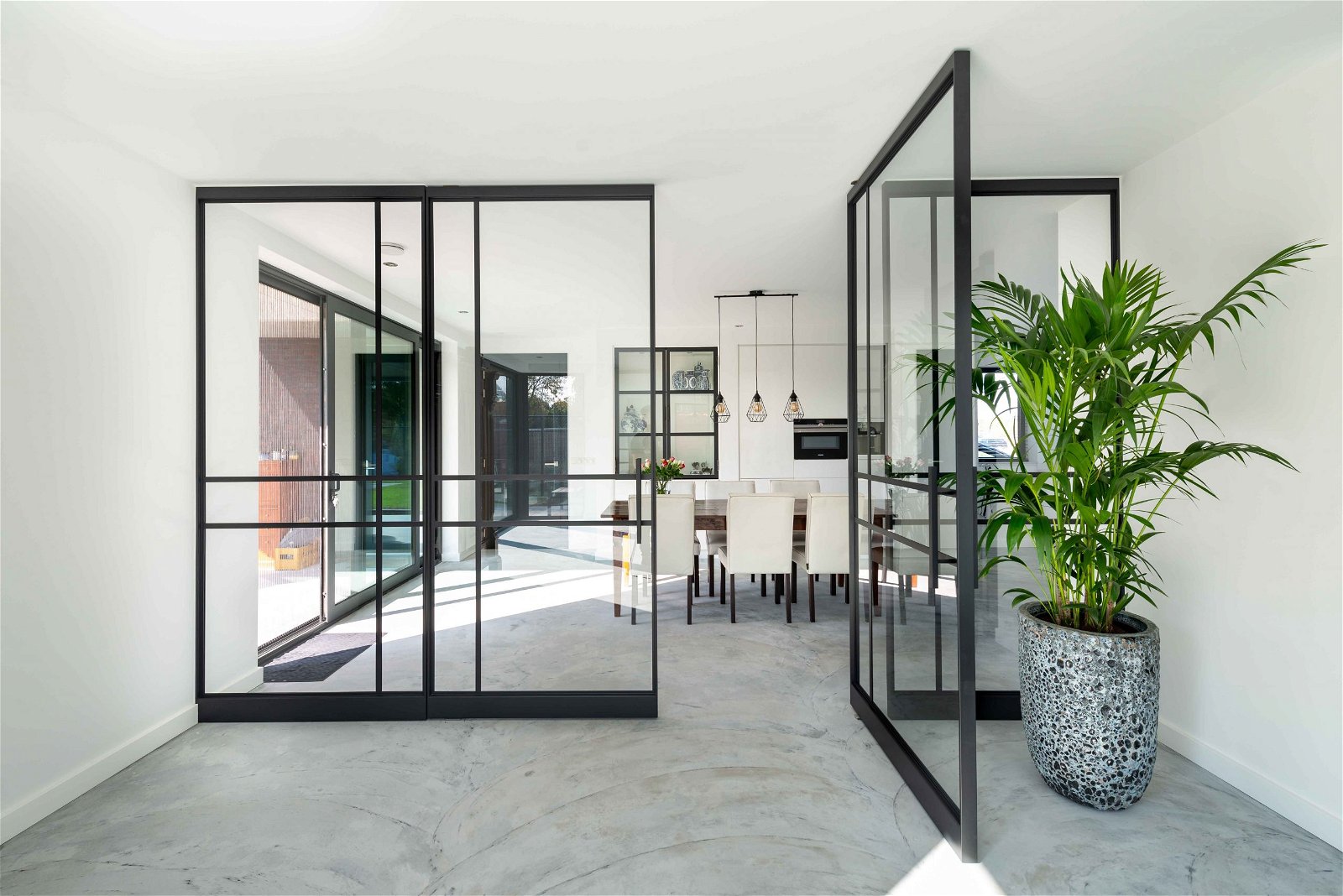Large glass pivot doors with a steel framework 2